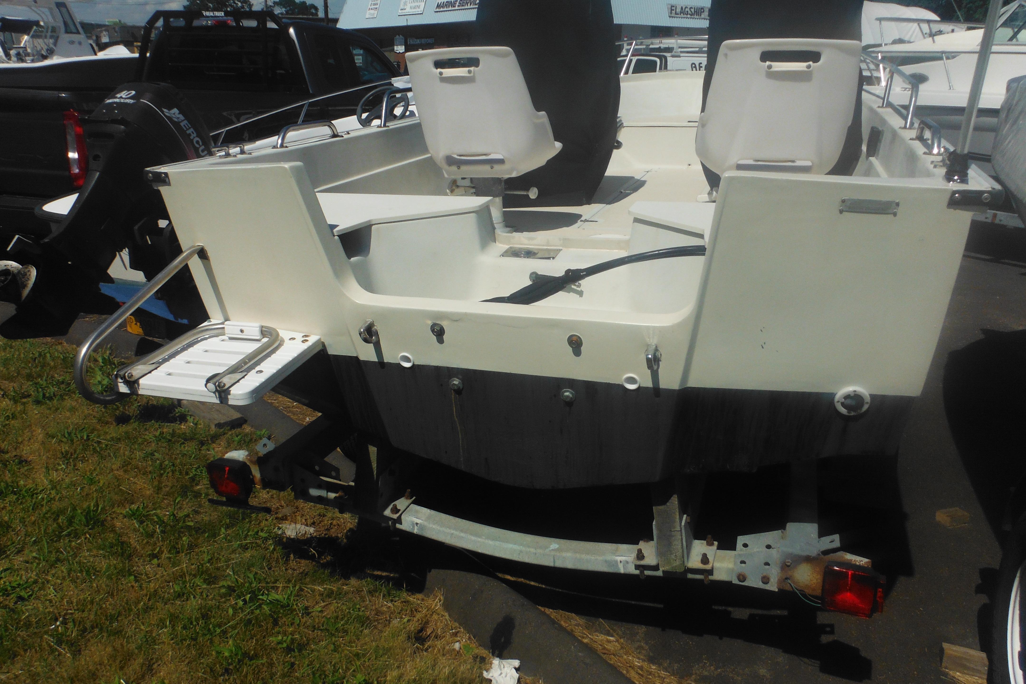 1991 Boston Whaler 16 SL boat on trailer, rear view with seating and ladder.