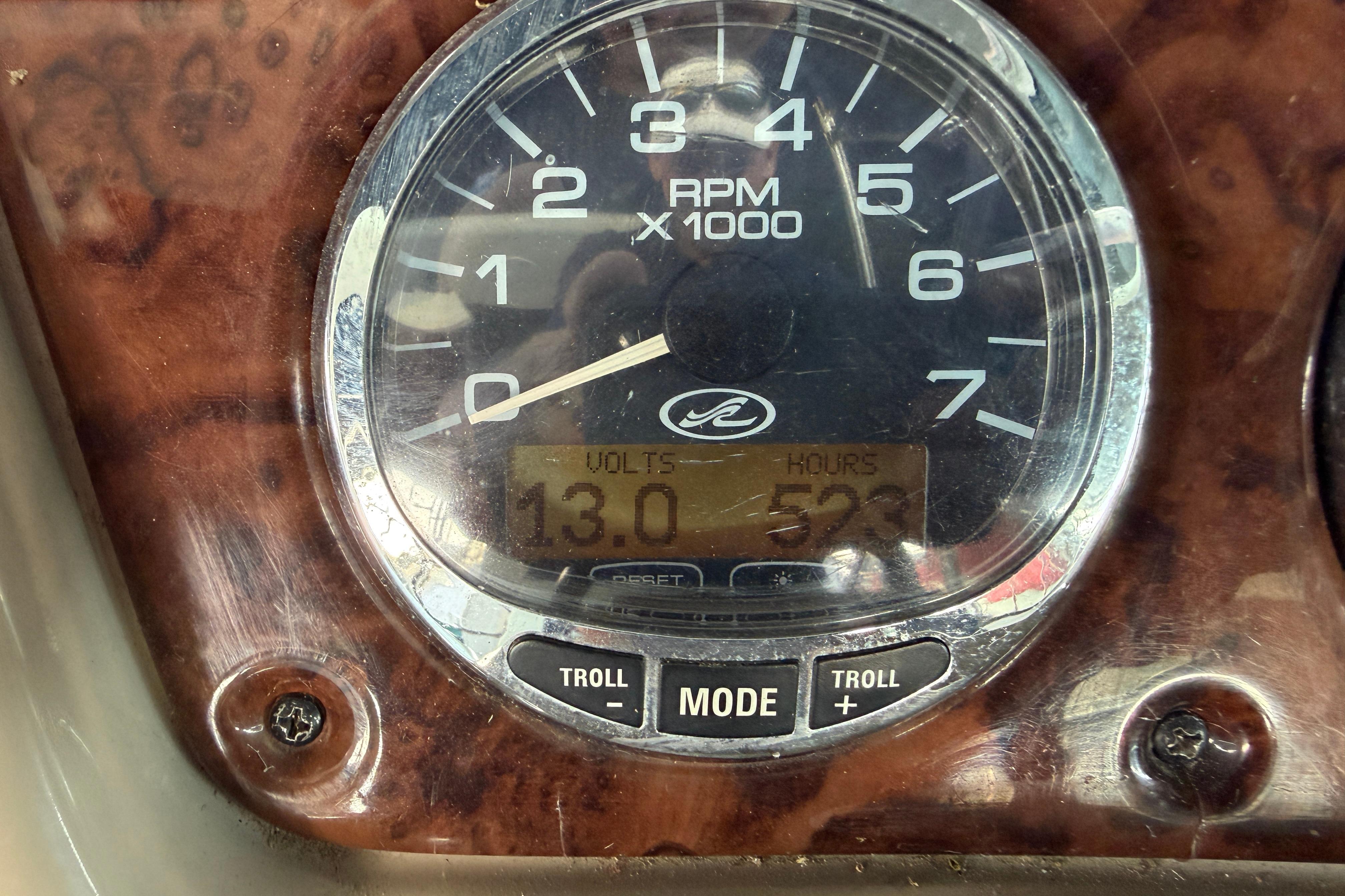 Close-up of a 2004 Sea Ray Sundancer 260 RPM gauge displaying 13 volts and 523 hours.