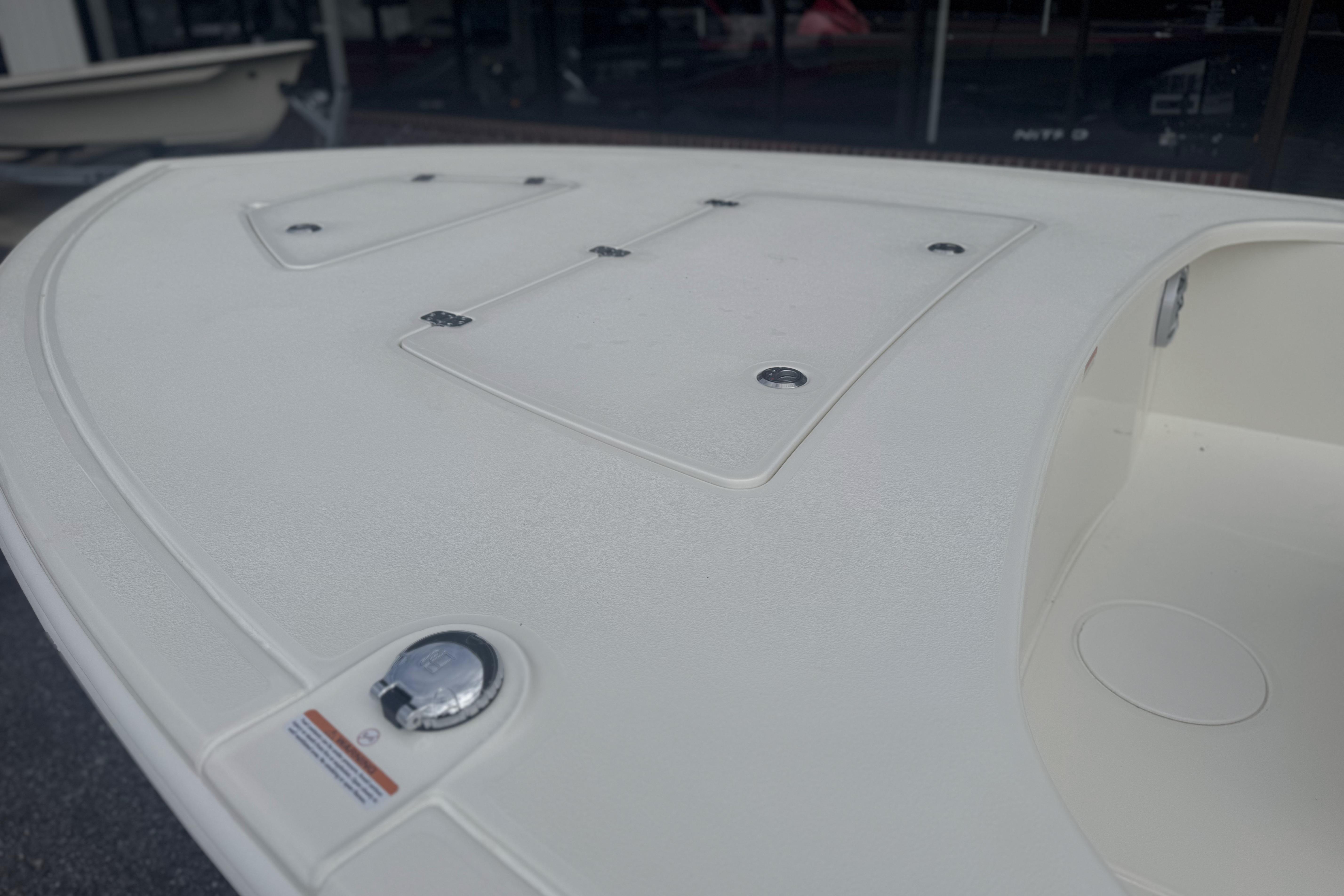 2026 Mako 18 Pro Skiff boat deck with storage compartments and sleek design.