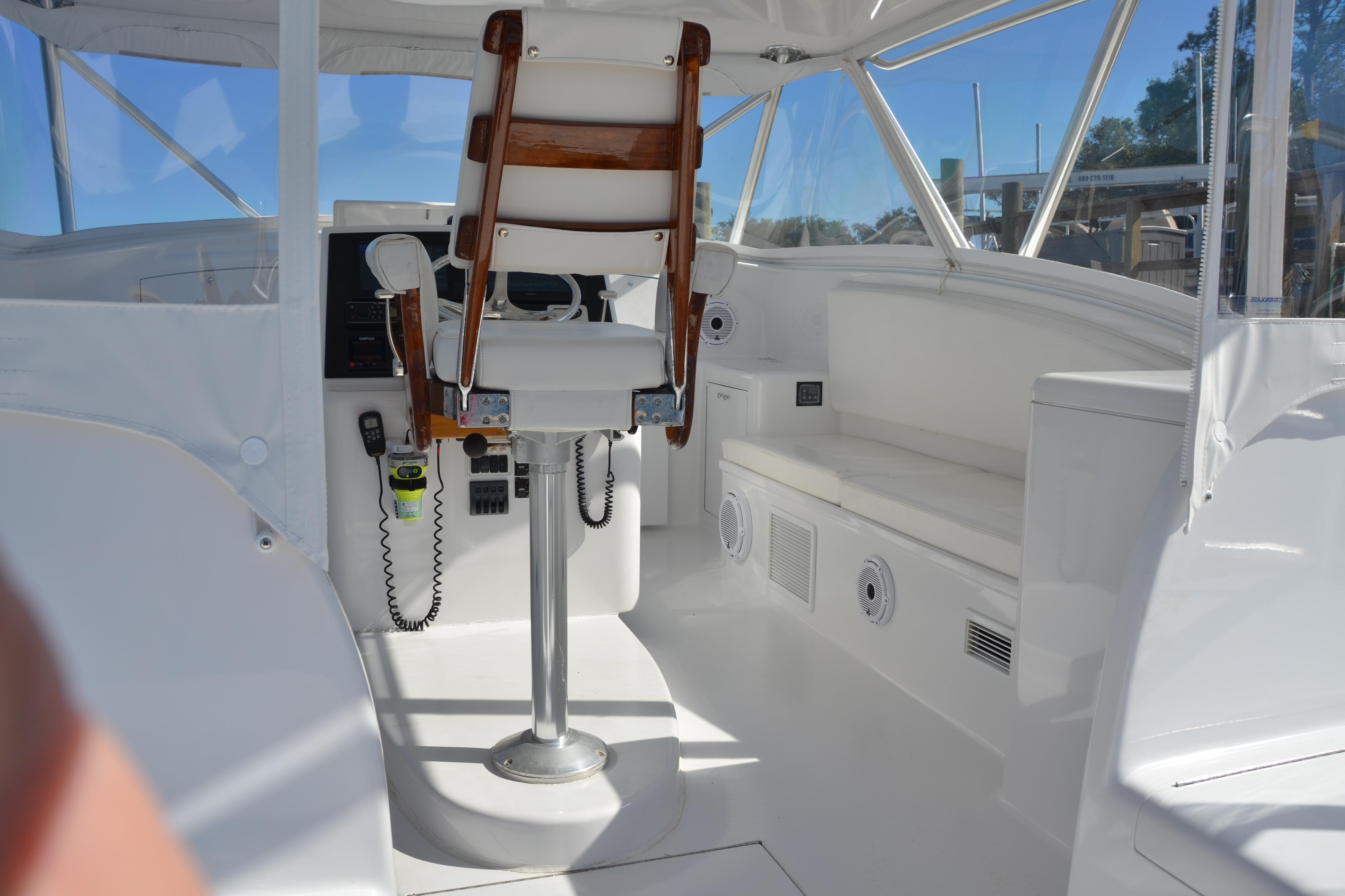 2006 Custom Carolina Heritage Express boat interior with captain's chair and navigation equipment.