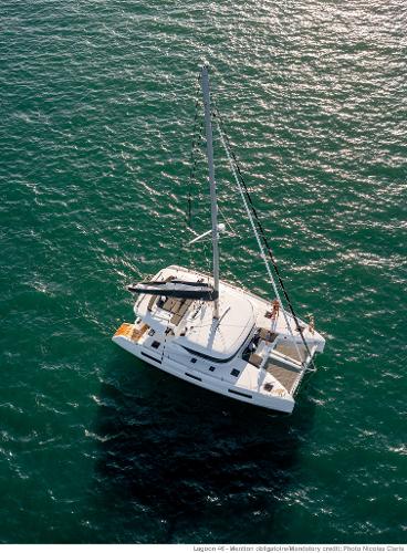 Aerial view of 2025 Lagoon 46 ICONIC catamaran sailing on open sea.