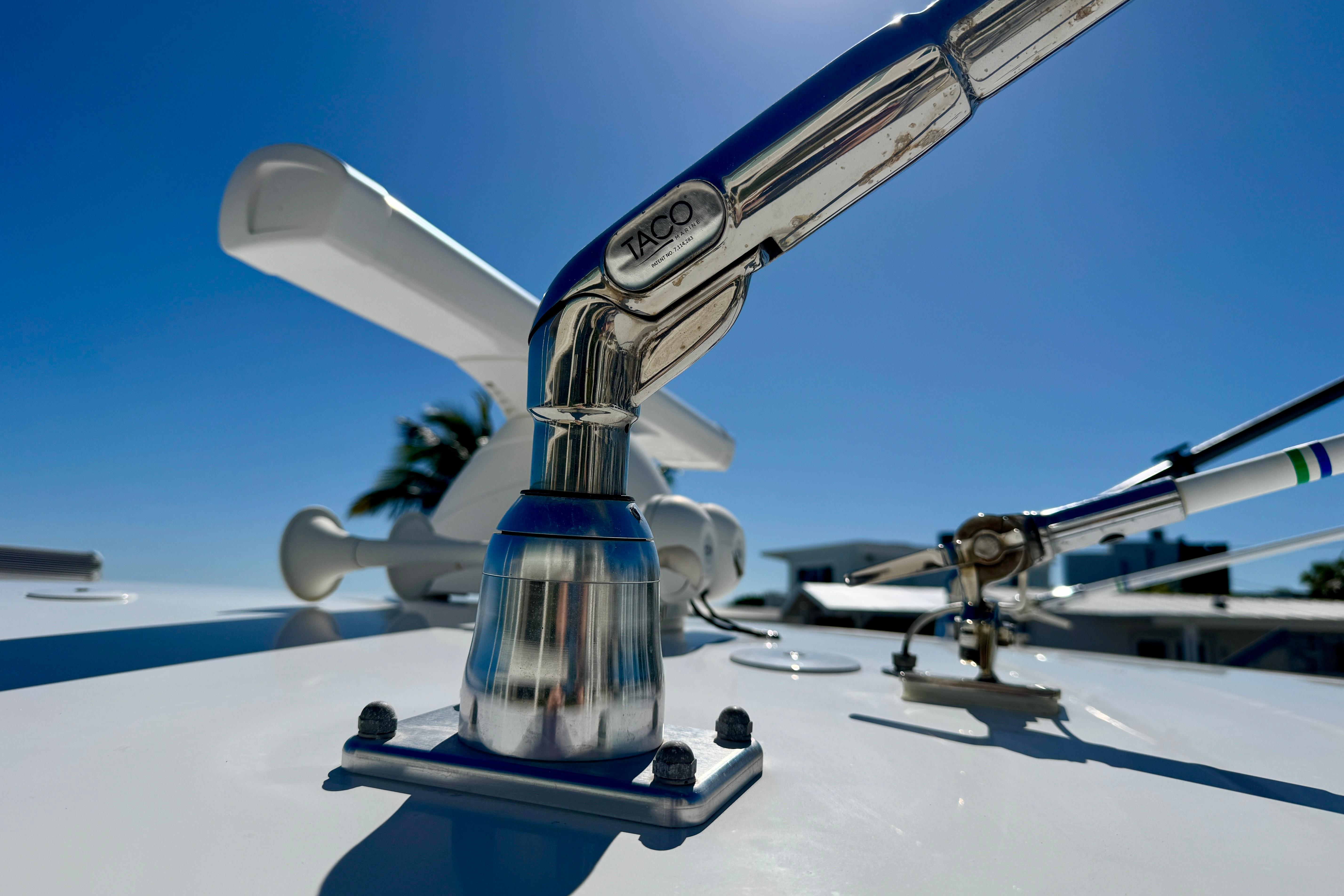 Close-up of 2024 Intrepid 407 Nomad FE boat hardware under clear blue sky.