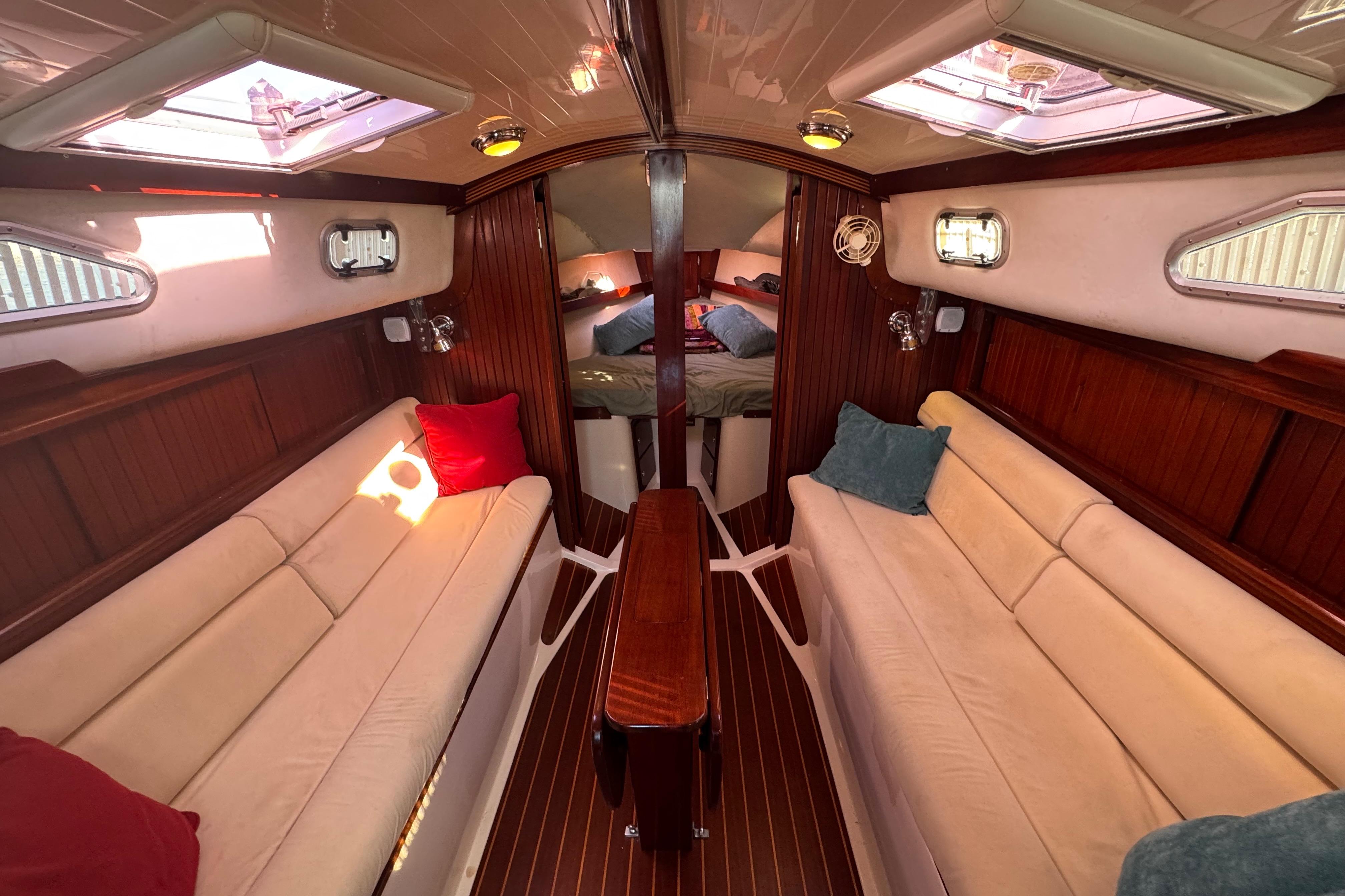 Interior of 2006 Shannon Shoalsailer yacht with cozy seating and elegant wood finish.