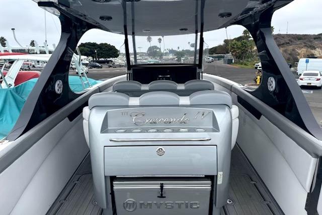 Luxury Mystic M4200 boat interior with sleek seating, docked at a marina, 2016 model.