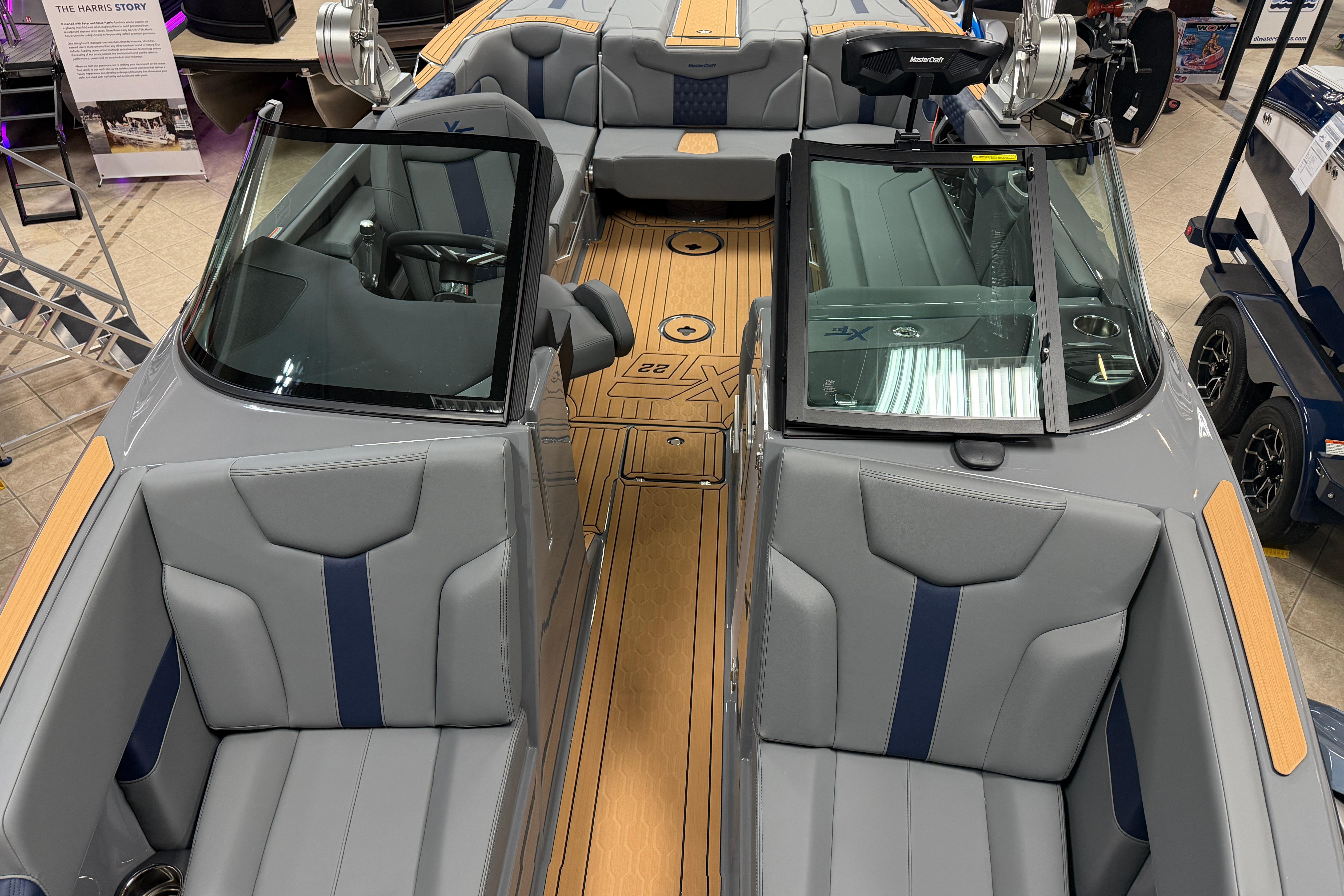 2026 MasterCraft XT22 boat interior with gray and blue seating, showcasing modern design.