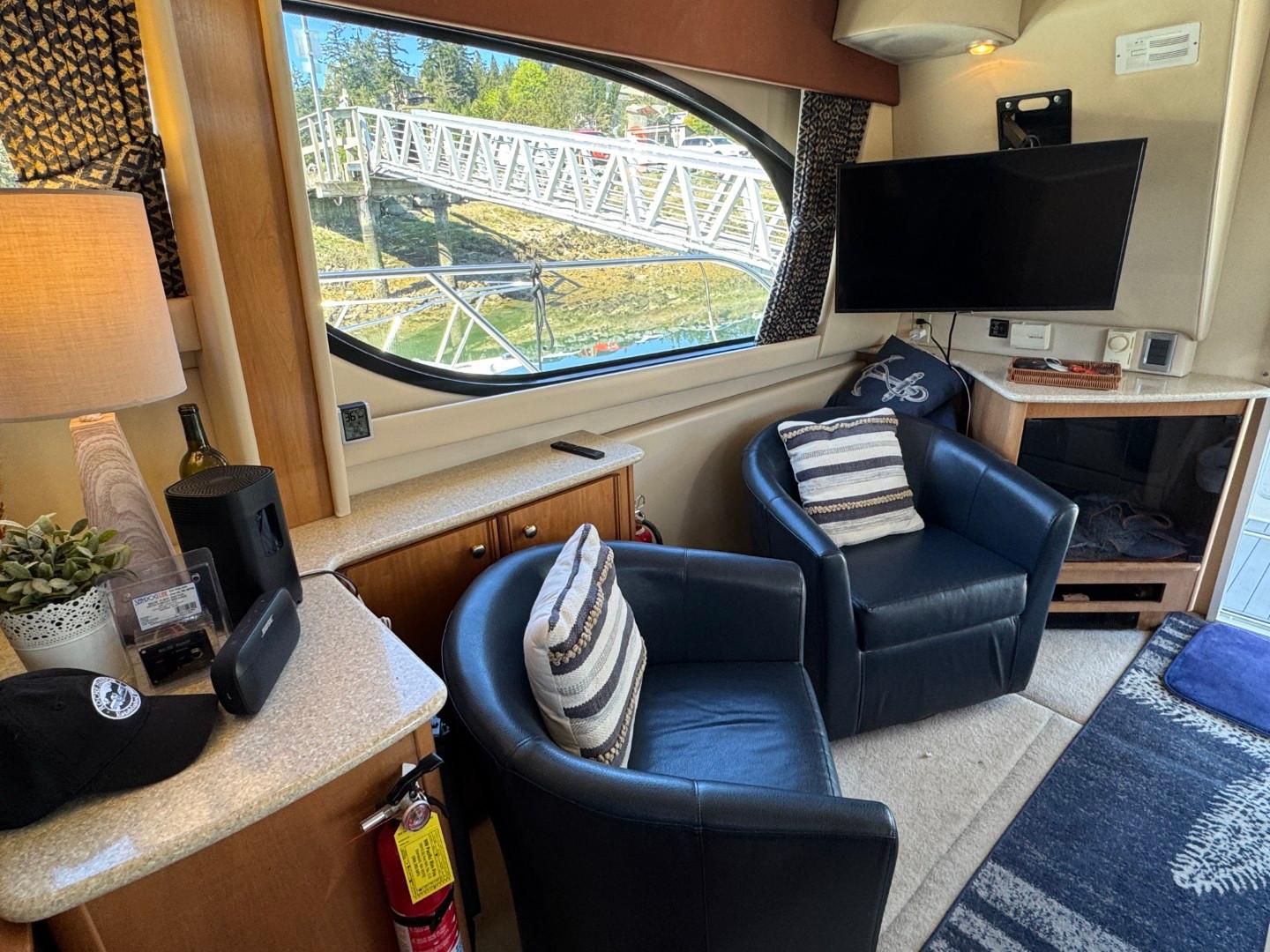 Interior of 2003 Meridian 381 Sedan with chairs, TV, and window view.