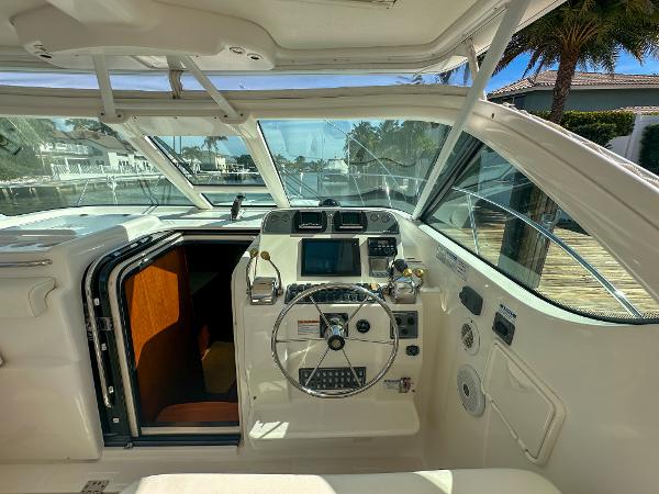 2006 Tiara Yachts 3200 Open helm with steering wheel and navigation controls.