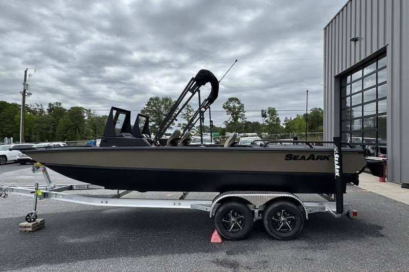 2026 SeaArk Predator 300 AK boat on trailer, parked outdoors near a building.