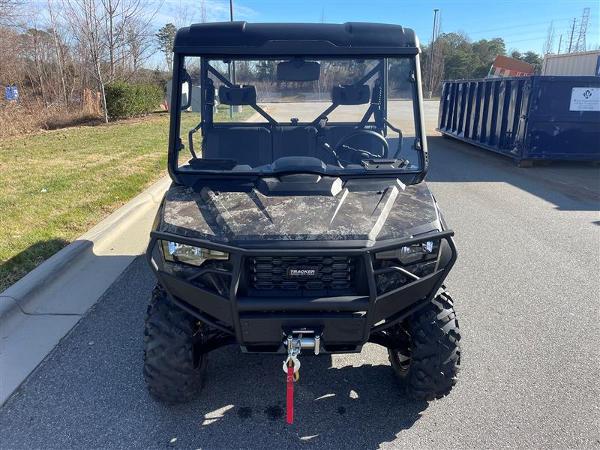 2024 Tracker Off Road 800SX LE Camo utility vehicle on pavement.