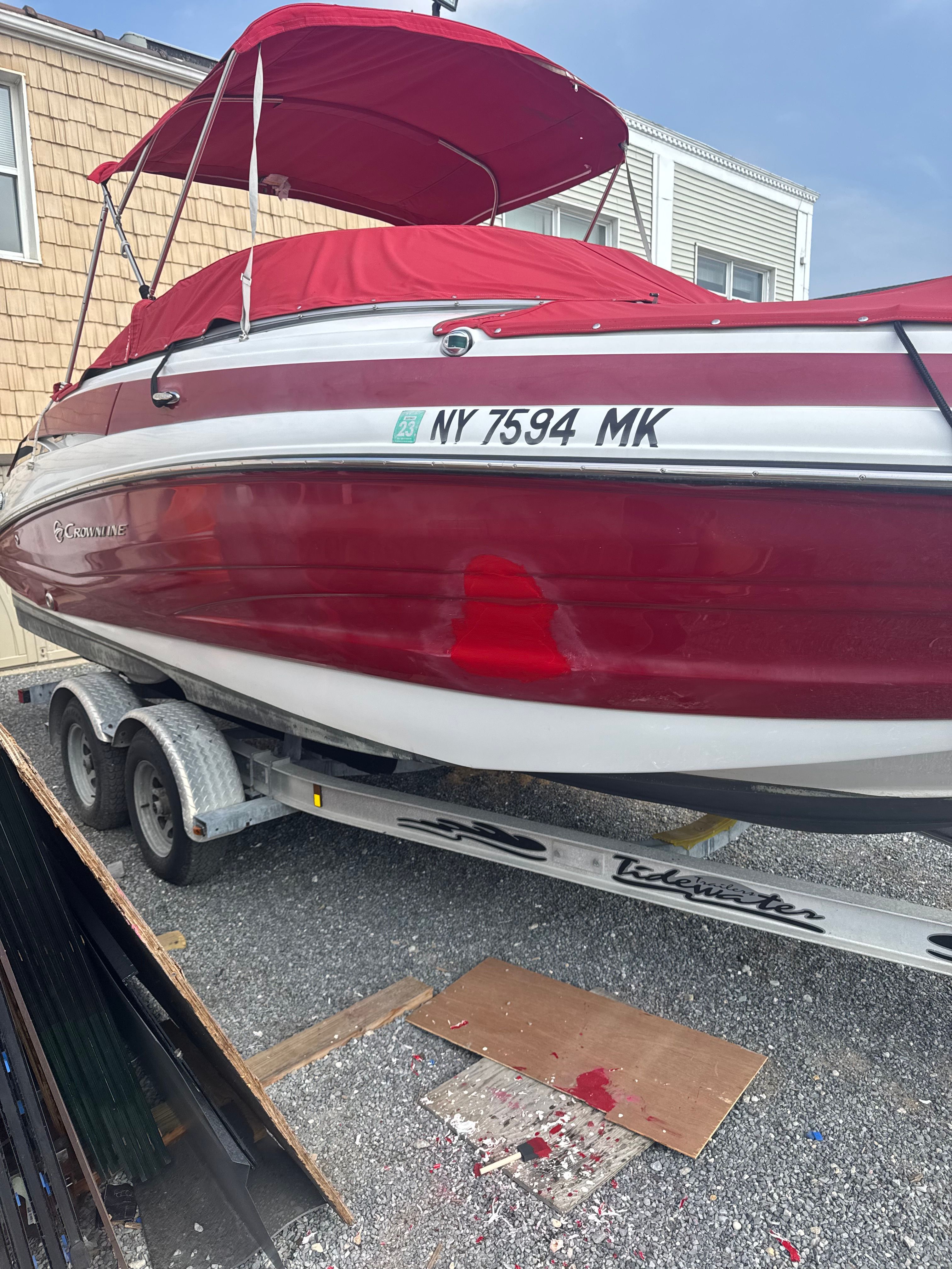 2014 Crownline Eclipse E2 boat on trailer with red canopy.