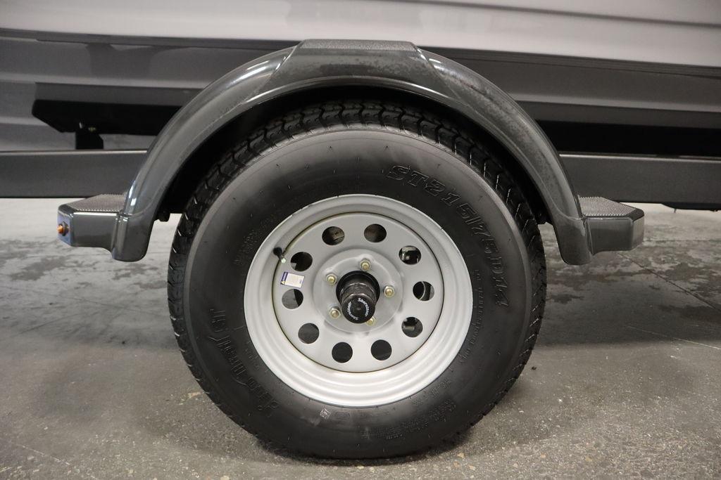 Trailer wheel of 2026 Yamaha Boats 195S, featuring a sturdy tire and metal rim.