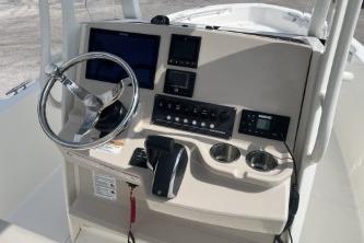 2024 Boston Whaler 220 Dauntless boat dashboard with steering wheel and control panel.