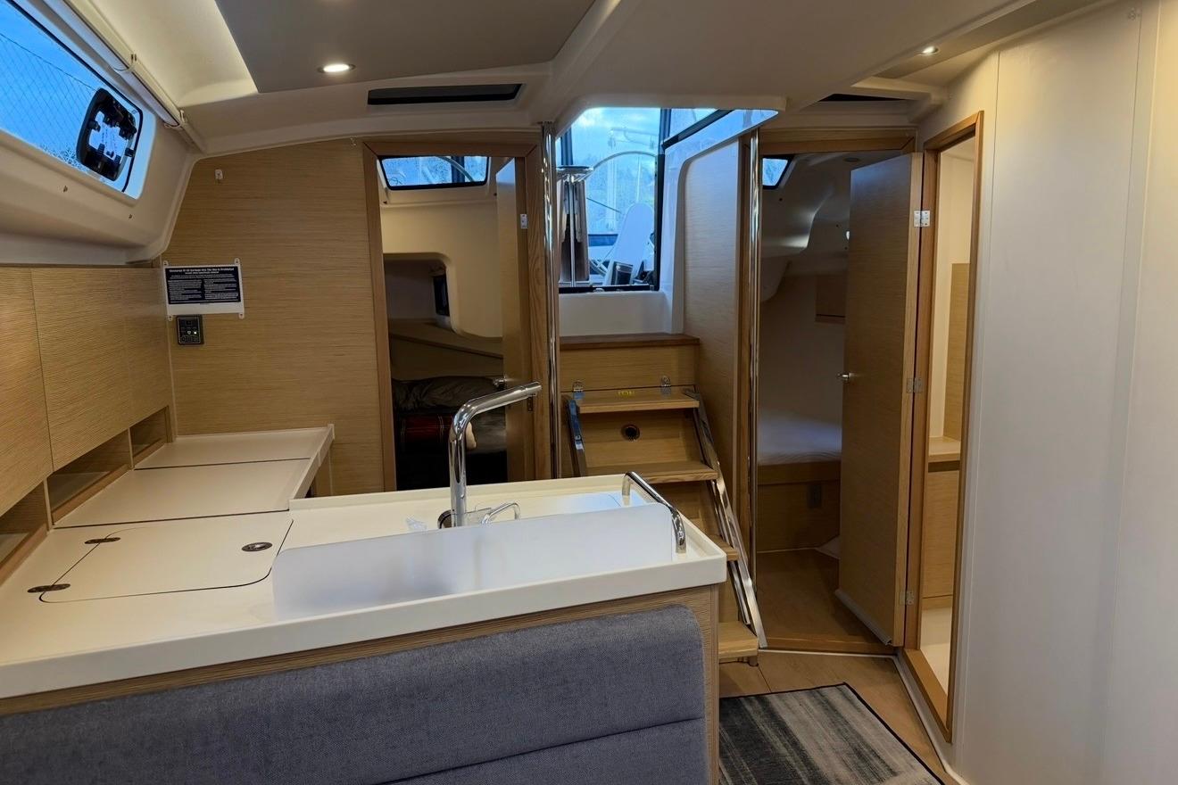Interior of 2022 Hanse 418 yacht featuring modern kitchen and cozy cabin spaces.