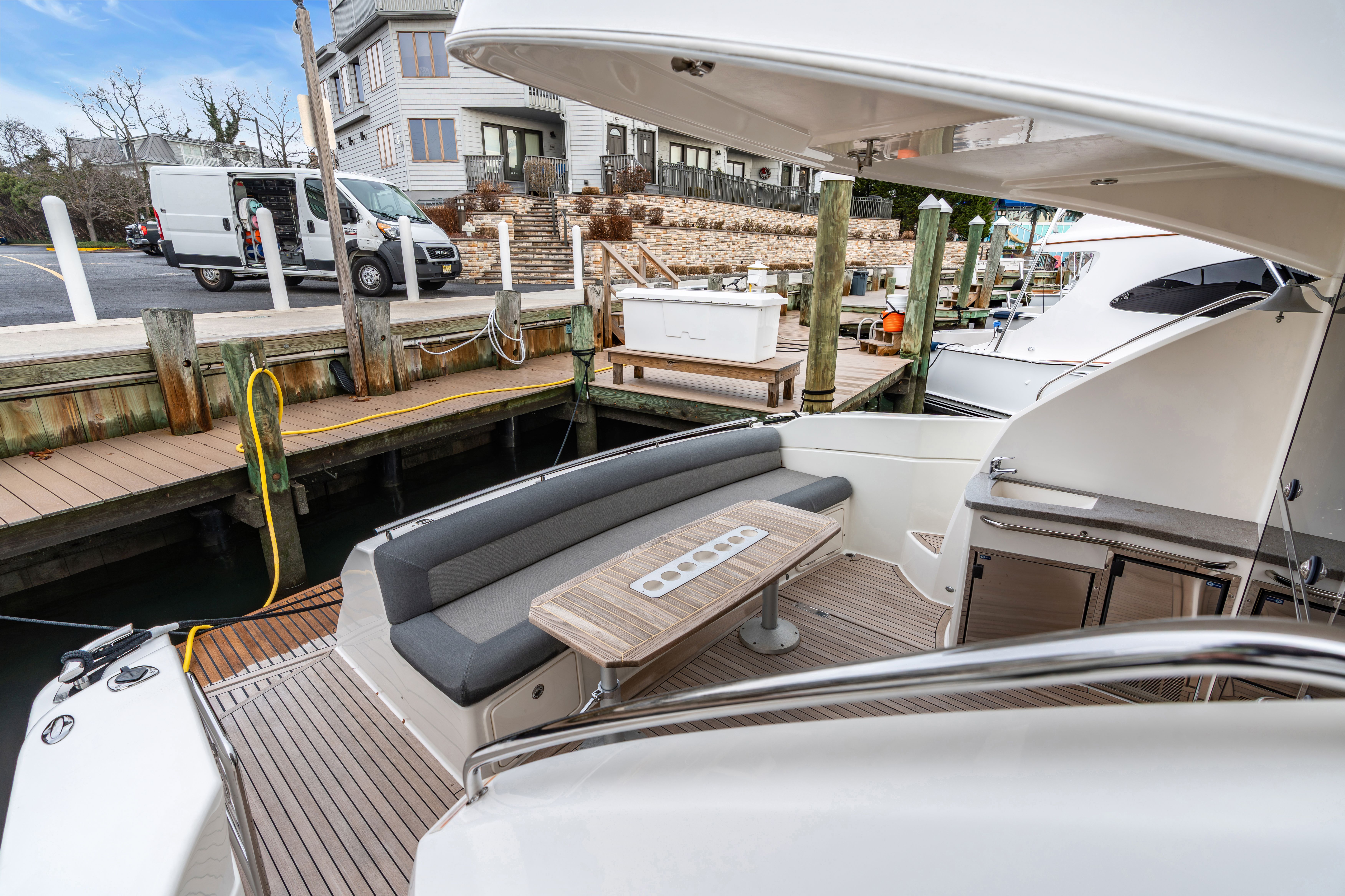 Riviera 44 Sport Yacht 2014 at dock with seating area.