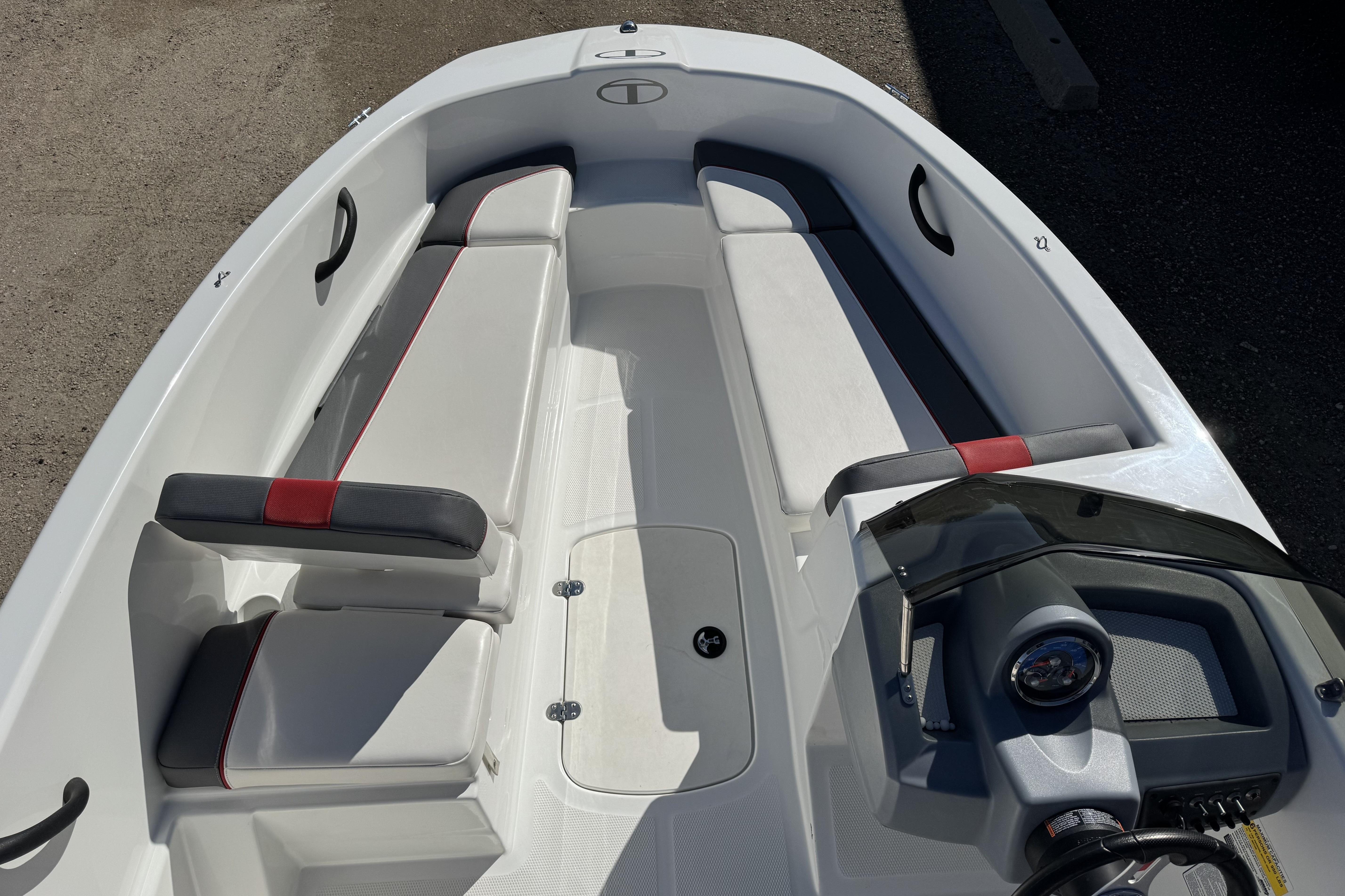 2021 Tahoe T16 boat interior with white and gray seating, red accents, and steering console.