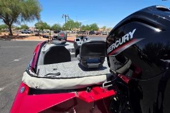 2025 Tracker Pro Team 175 boat with Mercury engine, parked outdoors under clear blue sky.