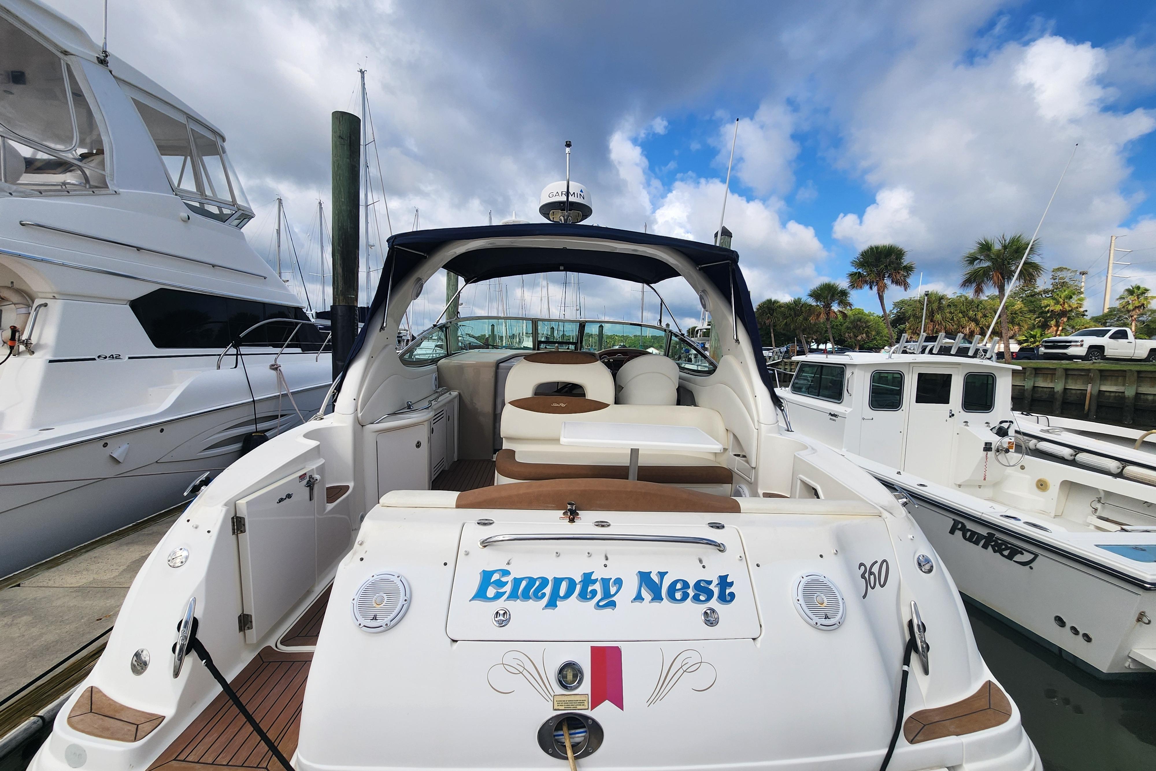 2003 Sea Ray 360 Sundancer yacht named "Empty Nest" docked at marina.