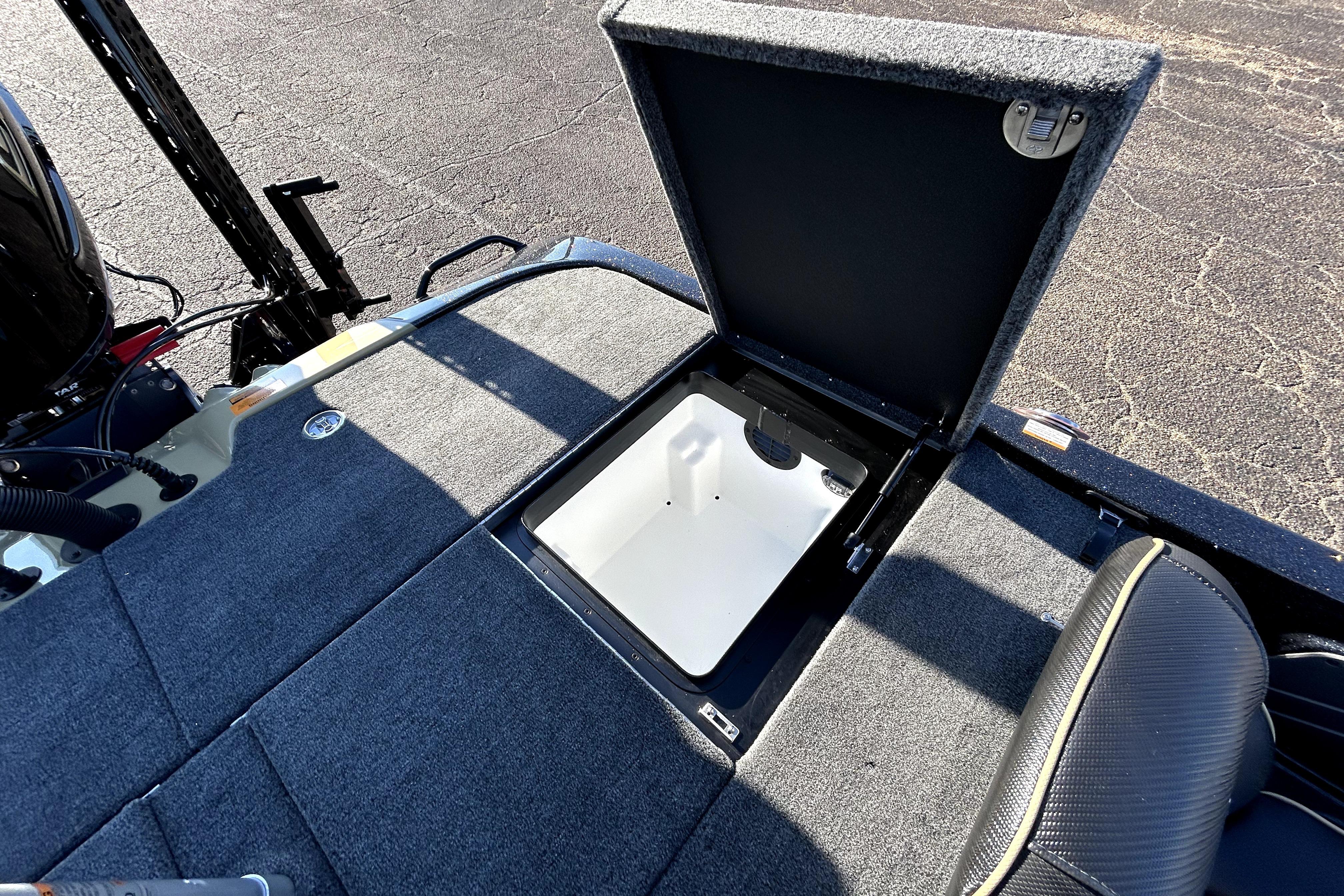 Open storage compartment on 2026 Skeeter ZXE21 boat deck, showing interior details.