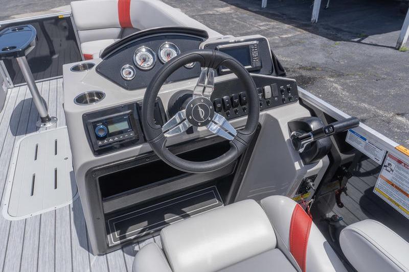 Helm of 2026 SunCatcher Select 322SL boat with modern controls and seating.