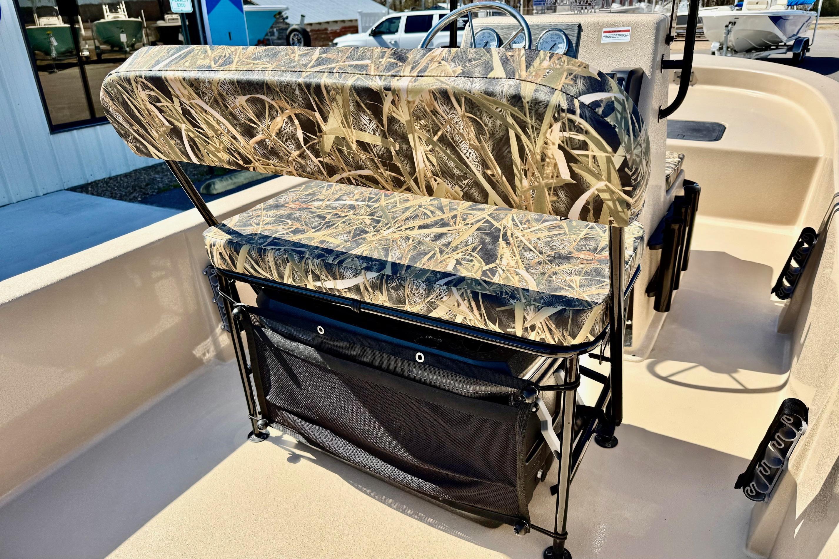 2026 Carolina Skiff E18 JVX CC boat interior with camo seating and storage.