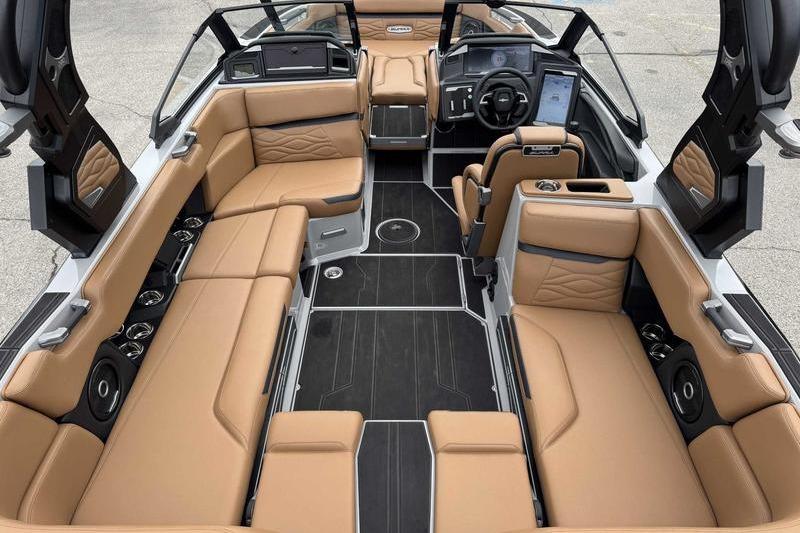 Luxurious 2026 Supra SA boat interior with tan leather seating and modern dashboard.