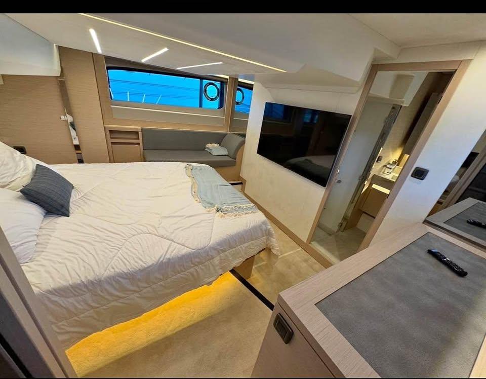 Luxurious bedroom interior of 2023 Prestige 520S yacht with modern amenities and elegant design.