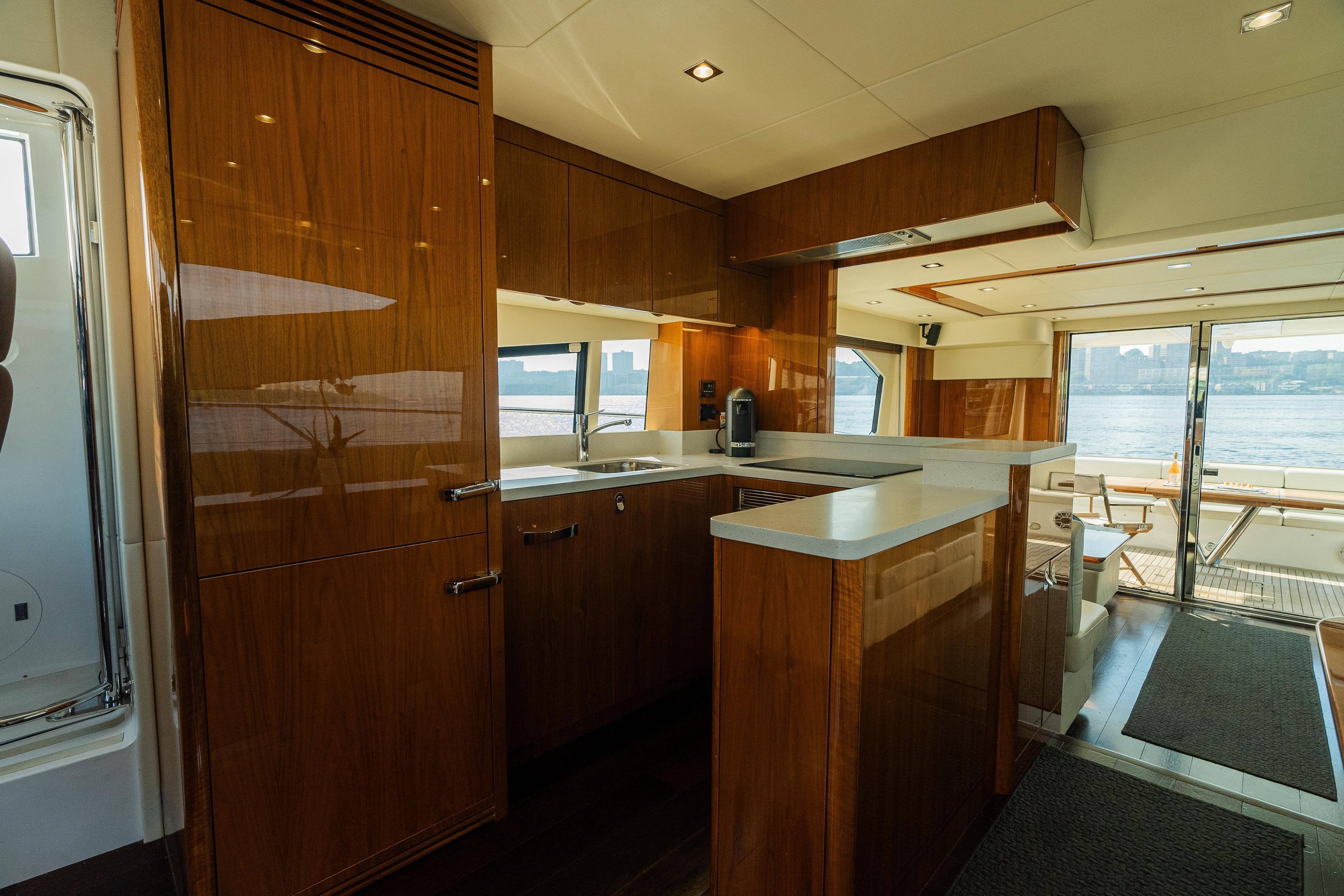 Luxurious interior of 2016 Sunseeker Manhattan 65 yacht with modern kitchen and waterfront view.