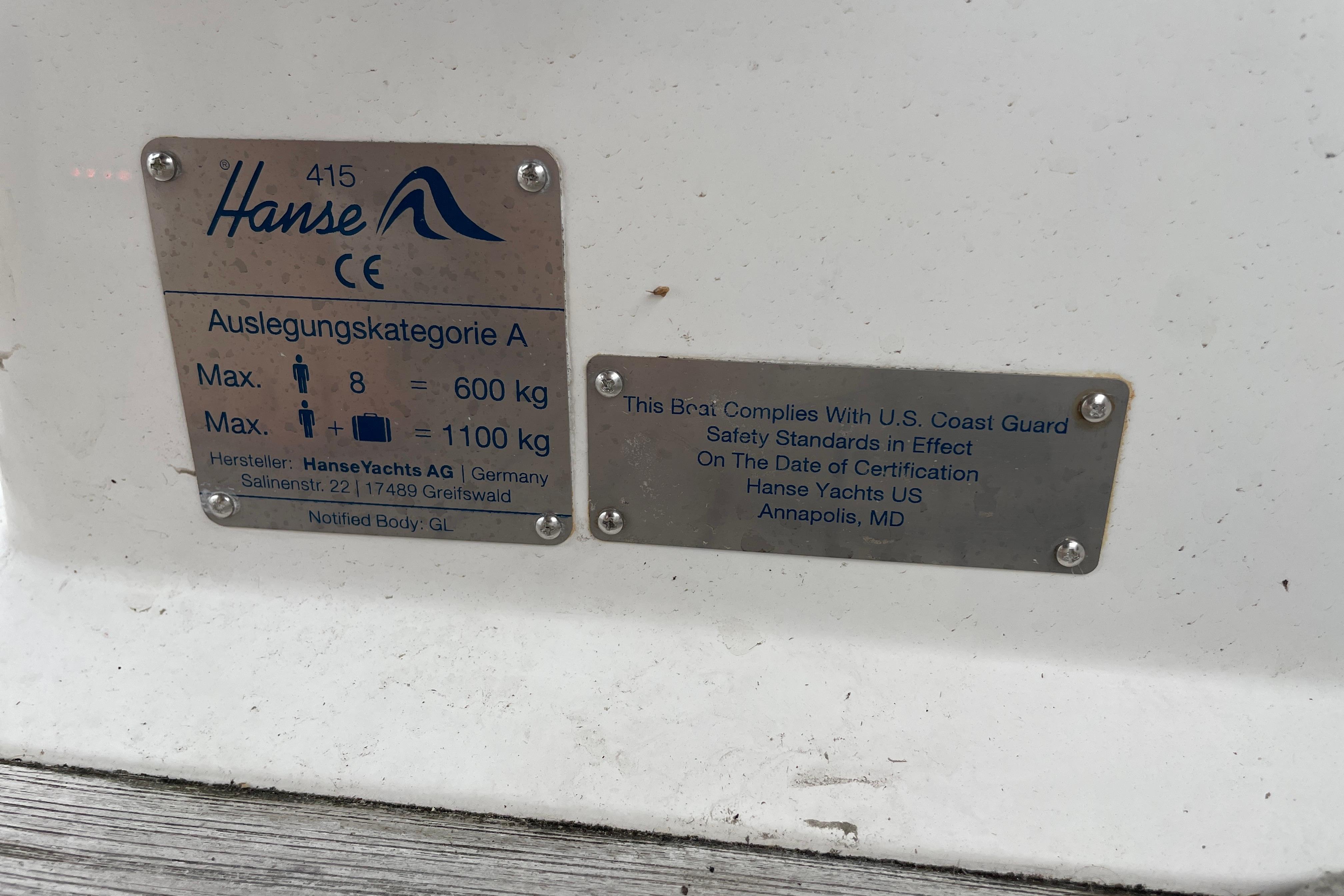 Plaques on a 2014 Hanse 415 yacht, detailing safety standards and weight limits.