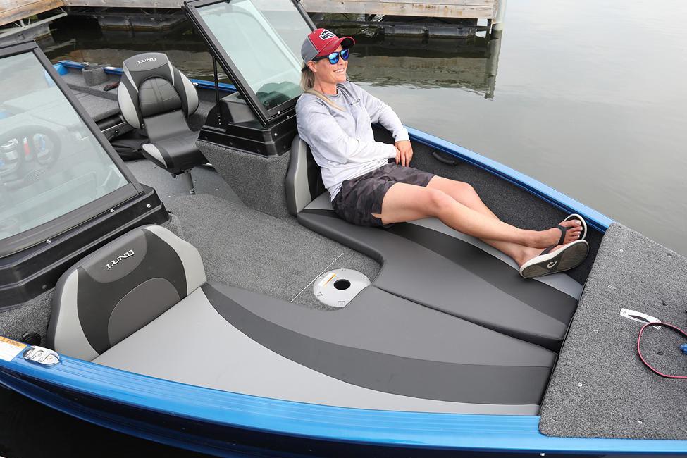 Manufacturer Provided Image: Person relaxing on a 2025 Lund 1775 Adventure Sport boat by the water.