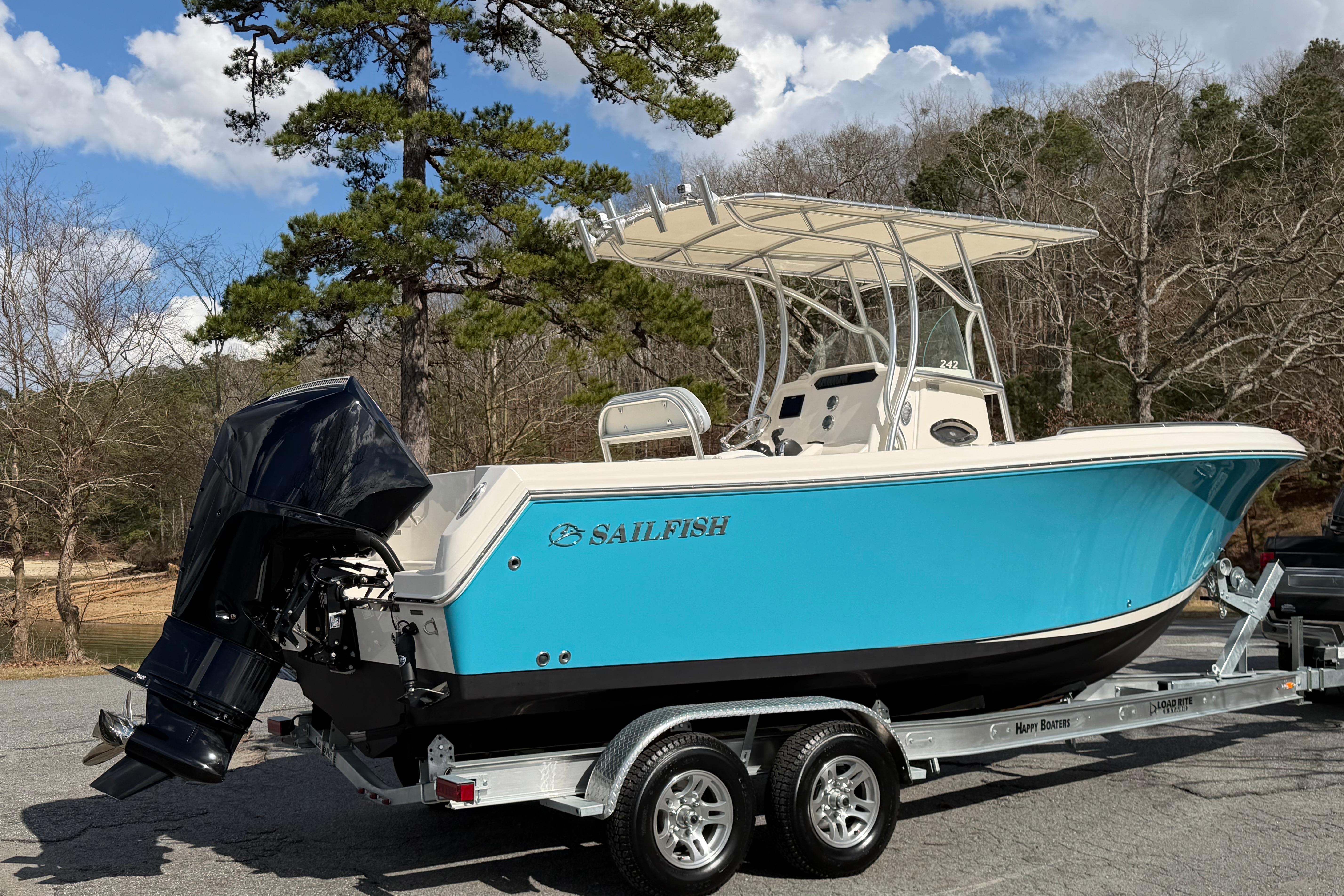 2022 Sailfish 242 CC boat on trailer, featuring a sleek blue hull and powerful outboard motor.