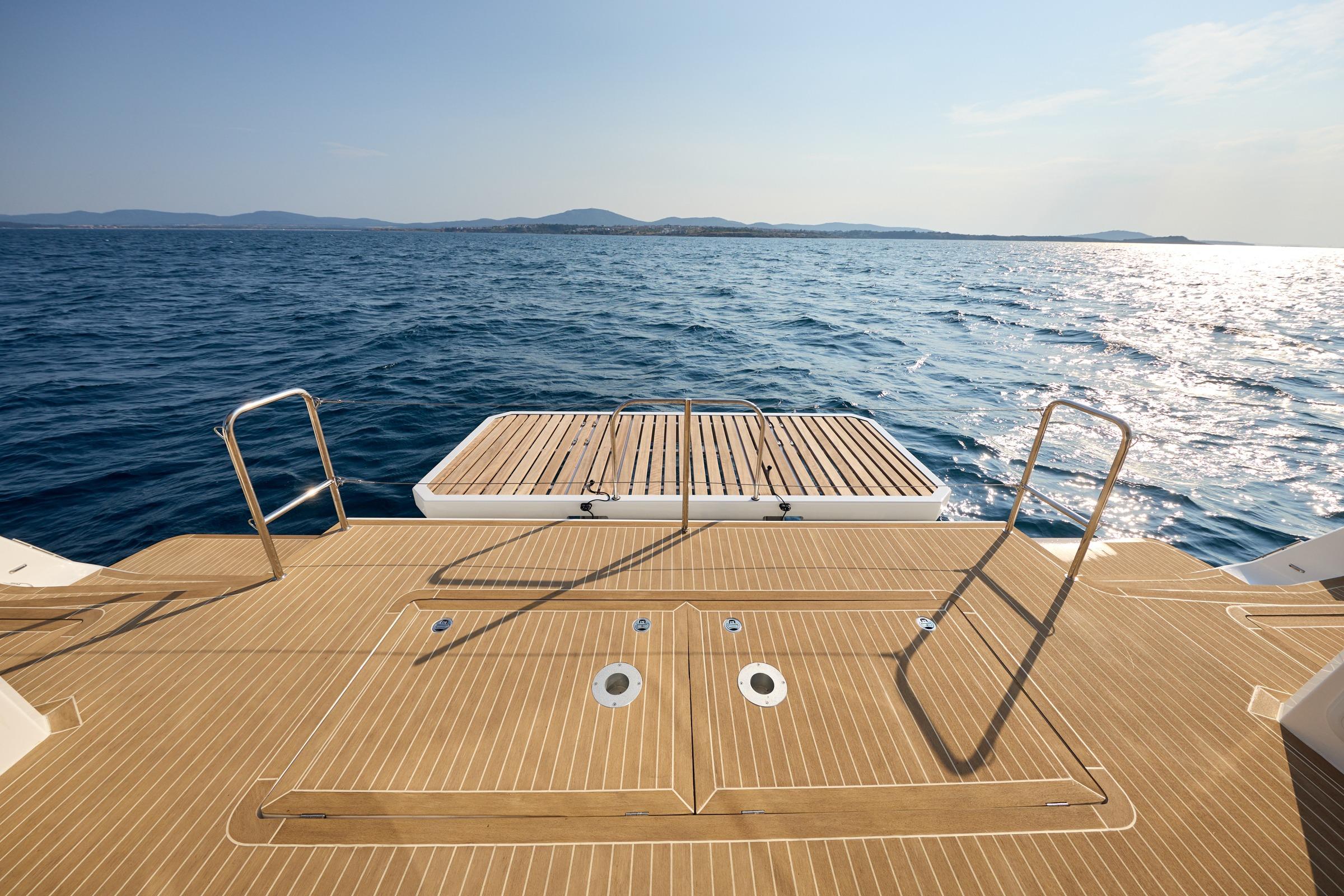2025 Custom Omaya 50 Power Catamaran deck overlooking serene ocean waters.