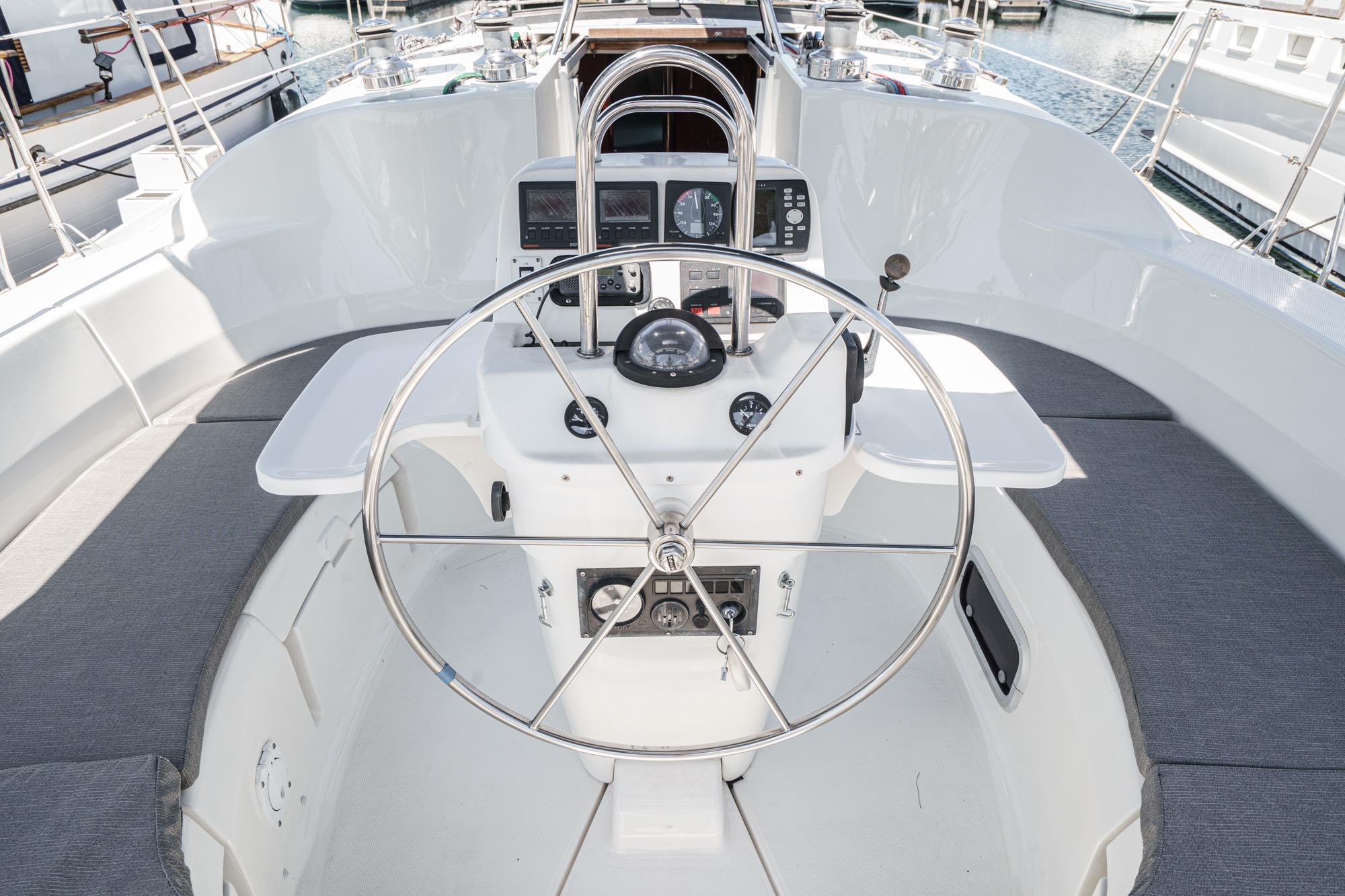 Cockpit of 1996 Hunter 376 sailboat with steering wheel and navigation instruments.