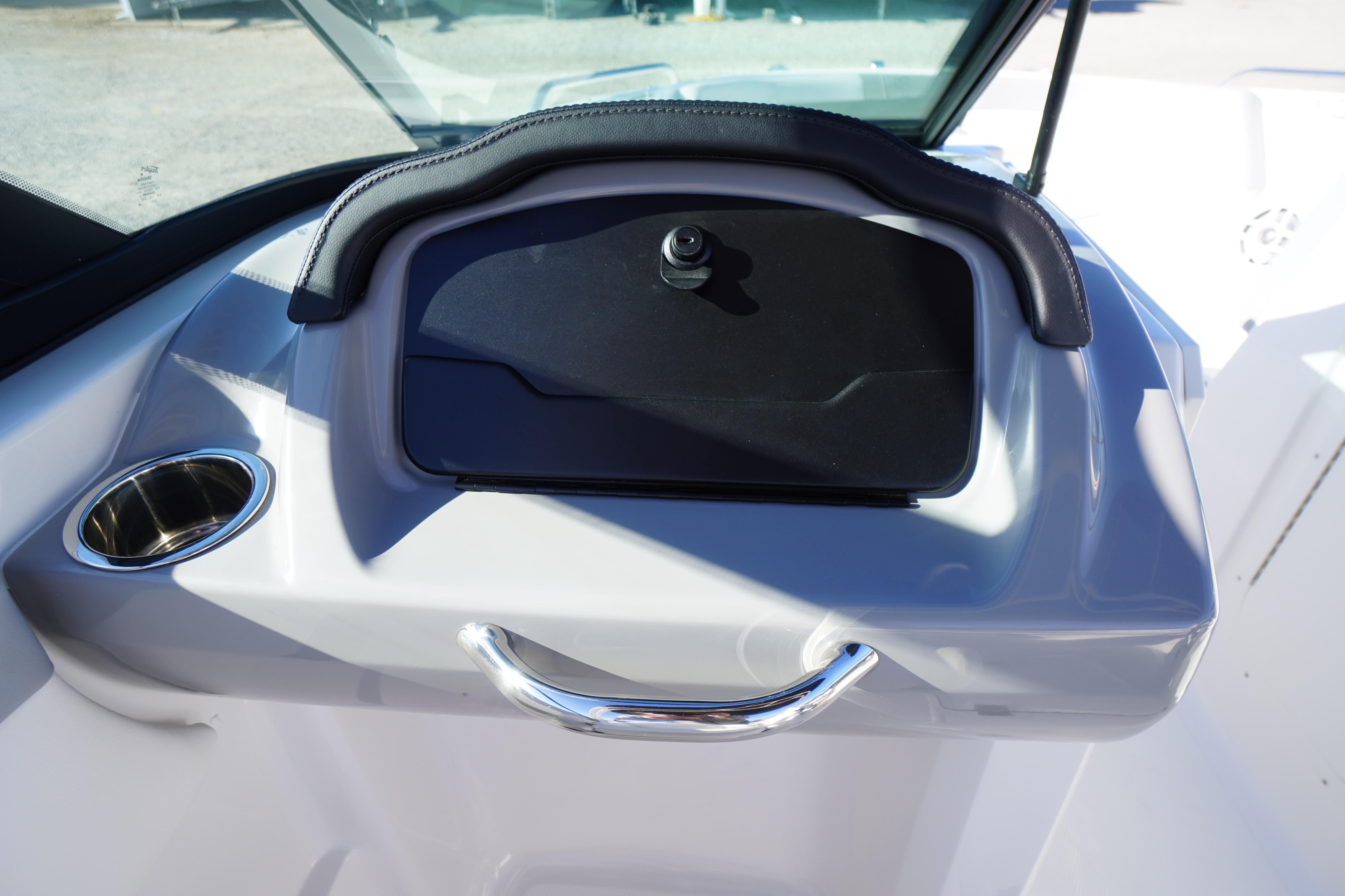 2026 Chaparral 23 SSi boat dashboard with cup holder and storage compartment.