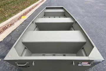 2026 Tracker Grizzly 10 Jon boat on pavement, showcasing interior seating and design.