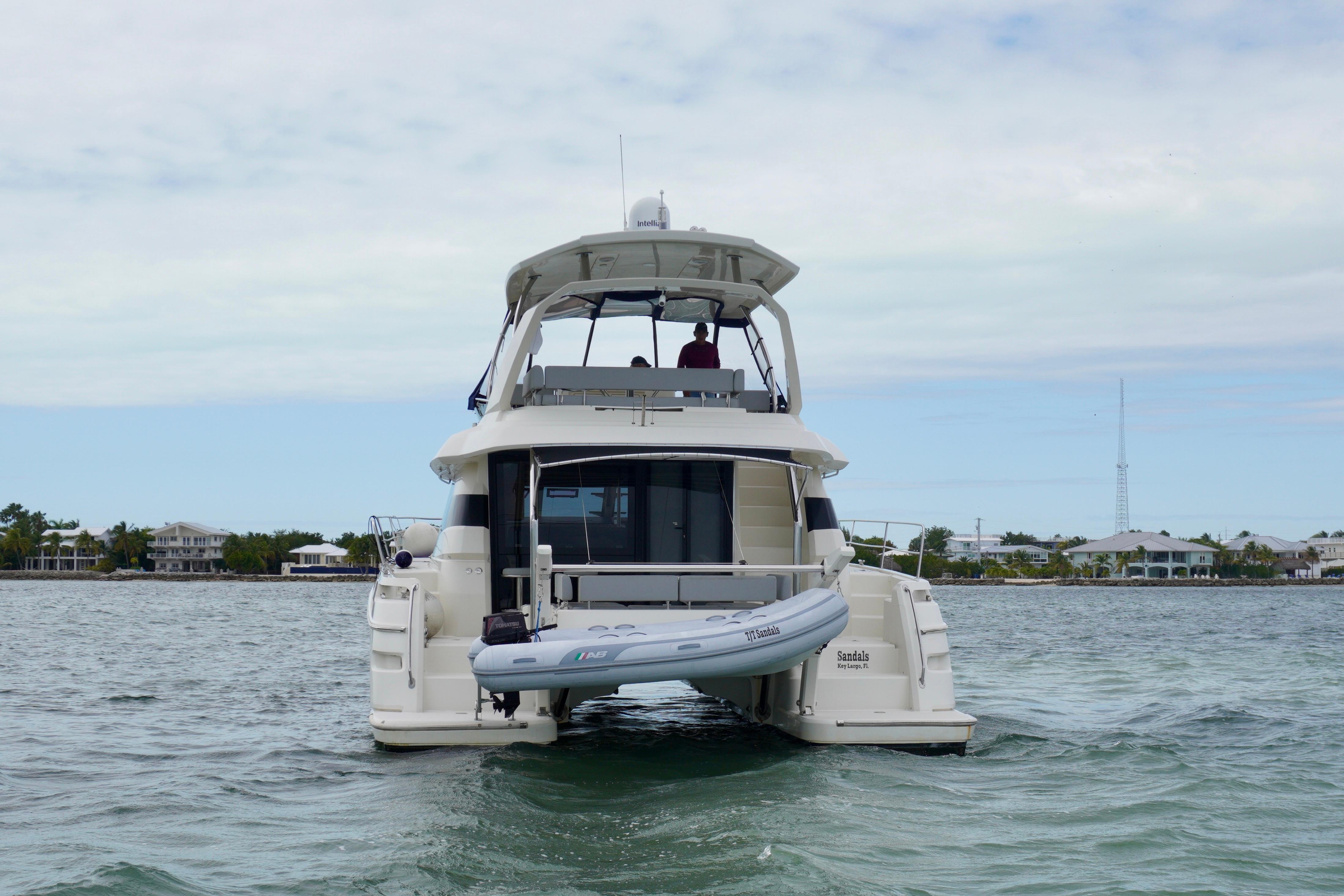 Aquila 44 Yacht 2017 on water, rear view with inflatable boat.