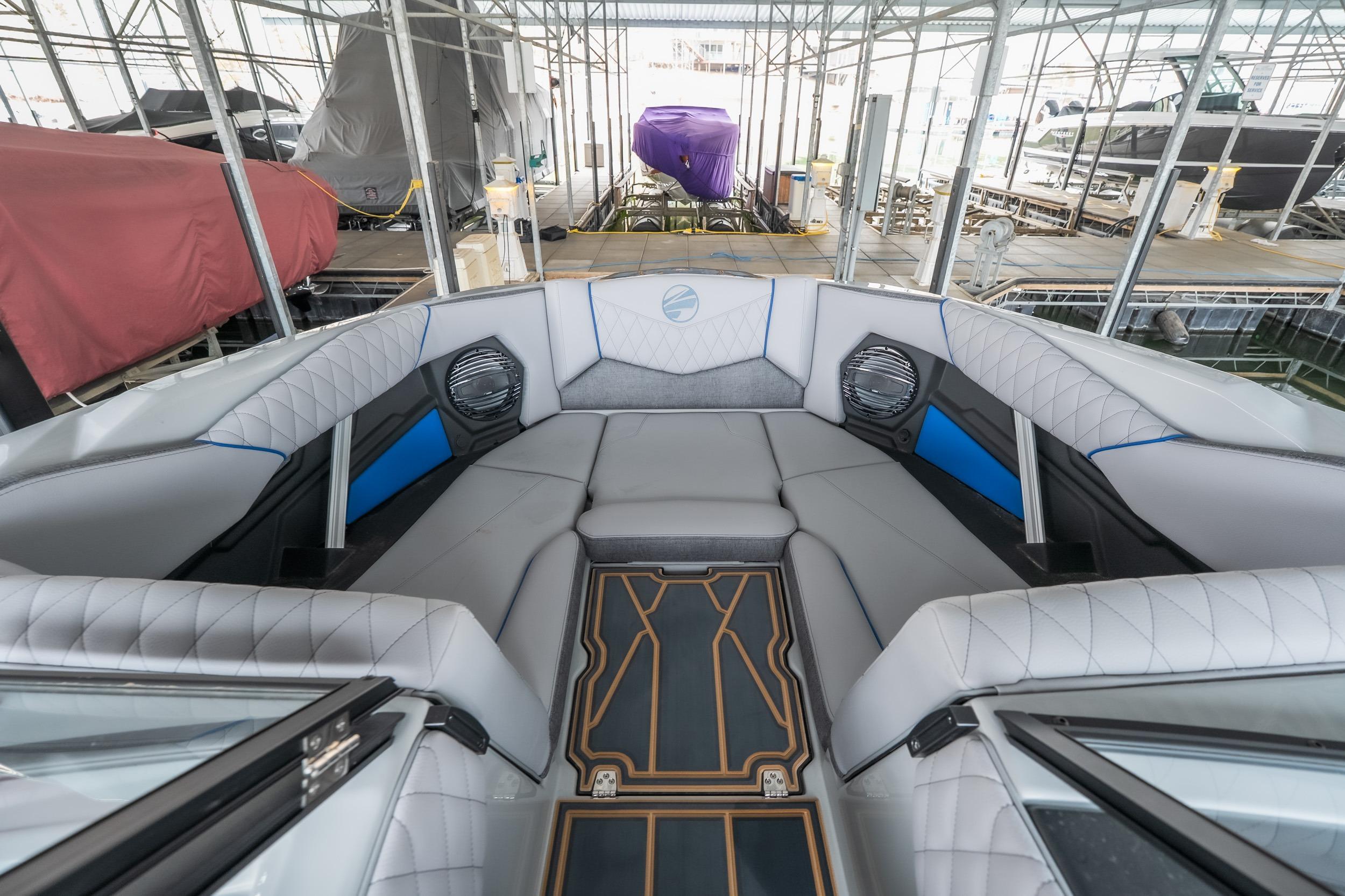 2026 Tigé Z3 boat interior with luxurious seating and modern design in a marina setting.