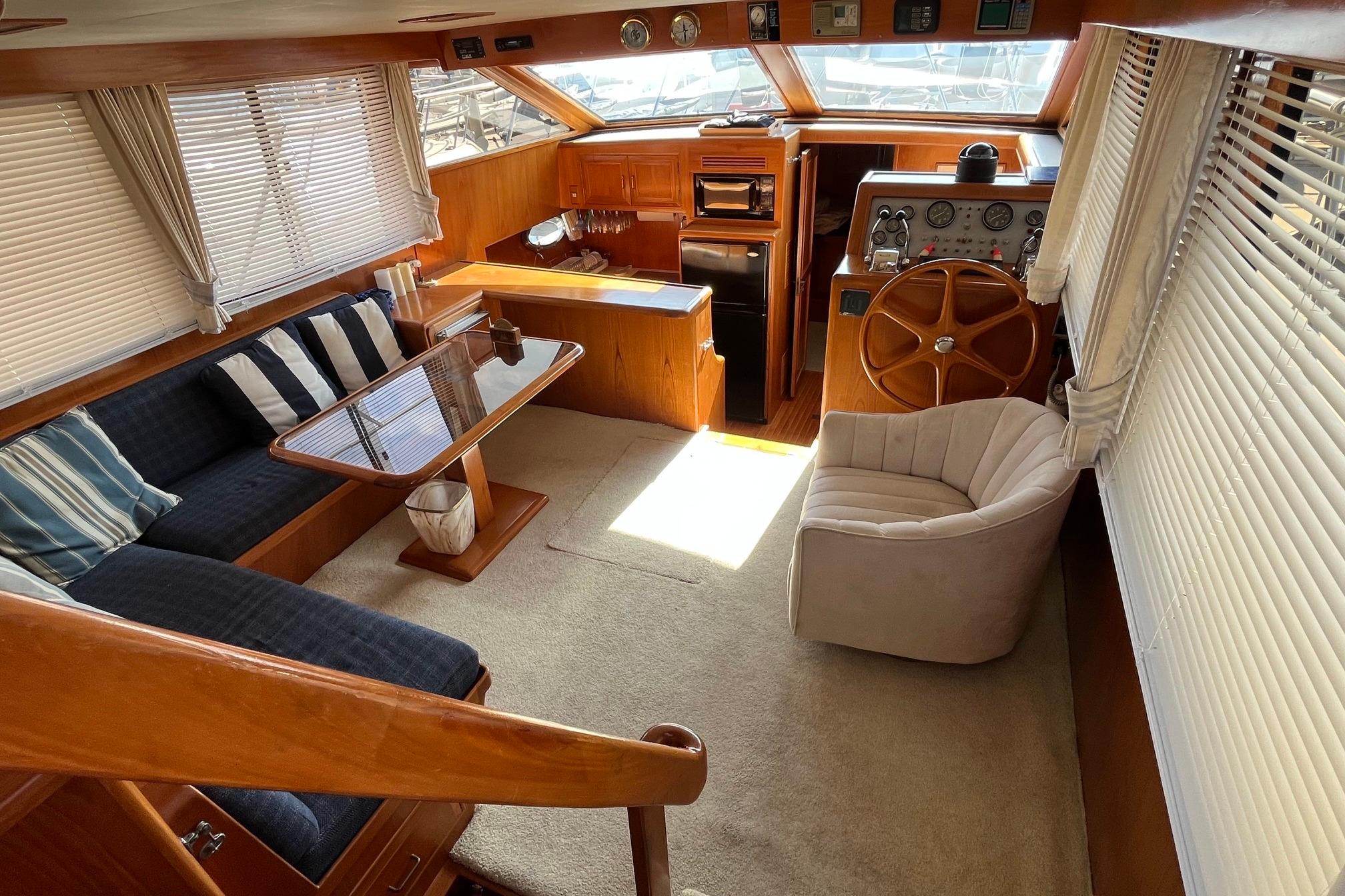 Luxurious interior of 1989 Ocean Alexander 440 Sundeck CPMY yacht with elegant seating and helm.