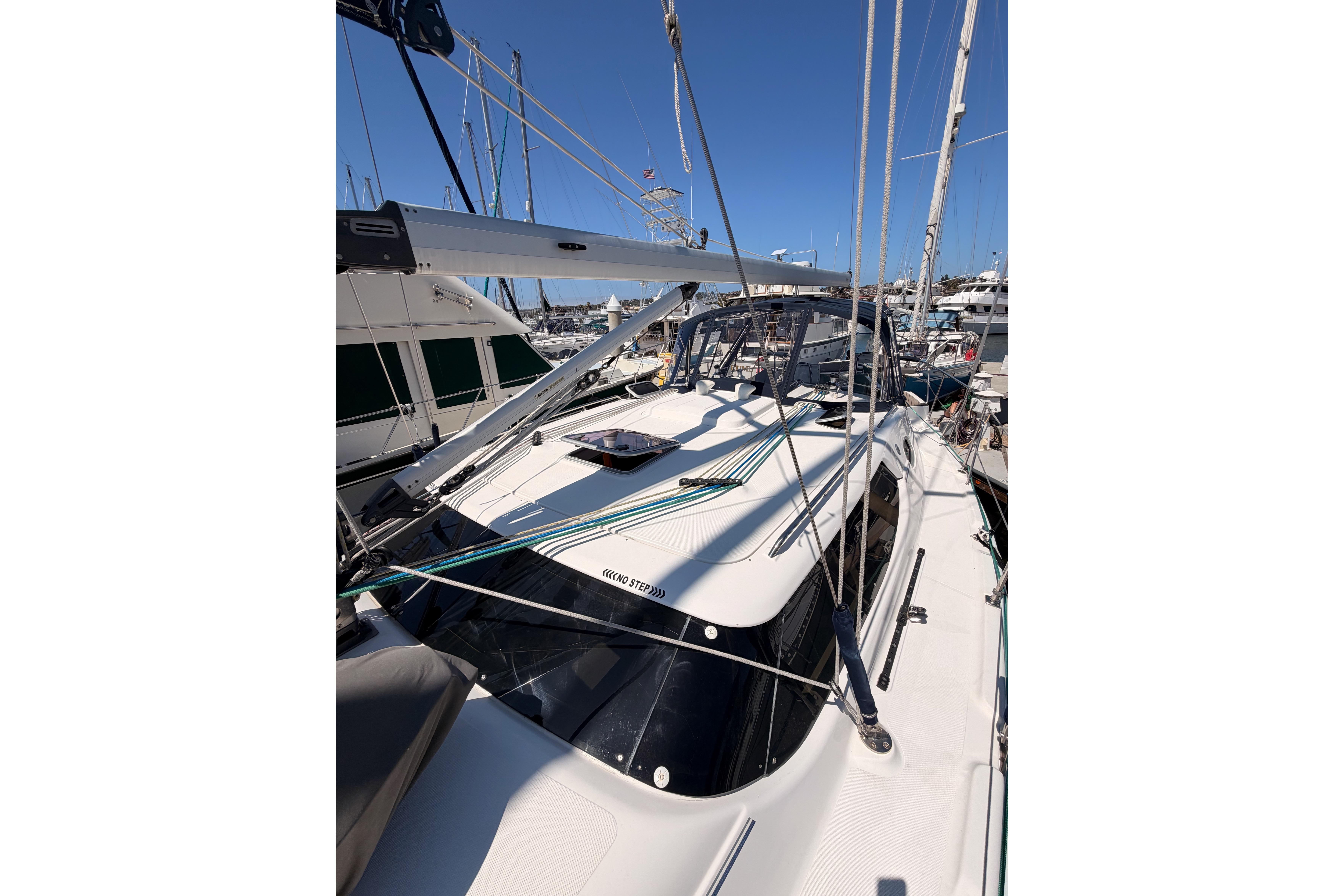 2008 Hunter 45 Deck Salon sailboat docked at marina under clear blue sky.