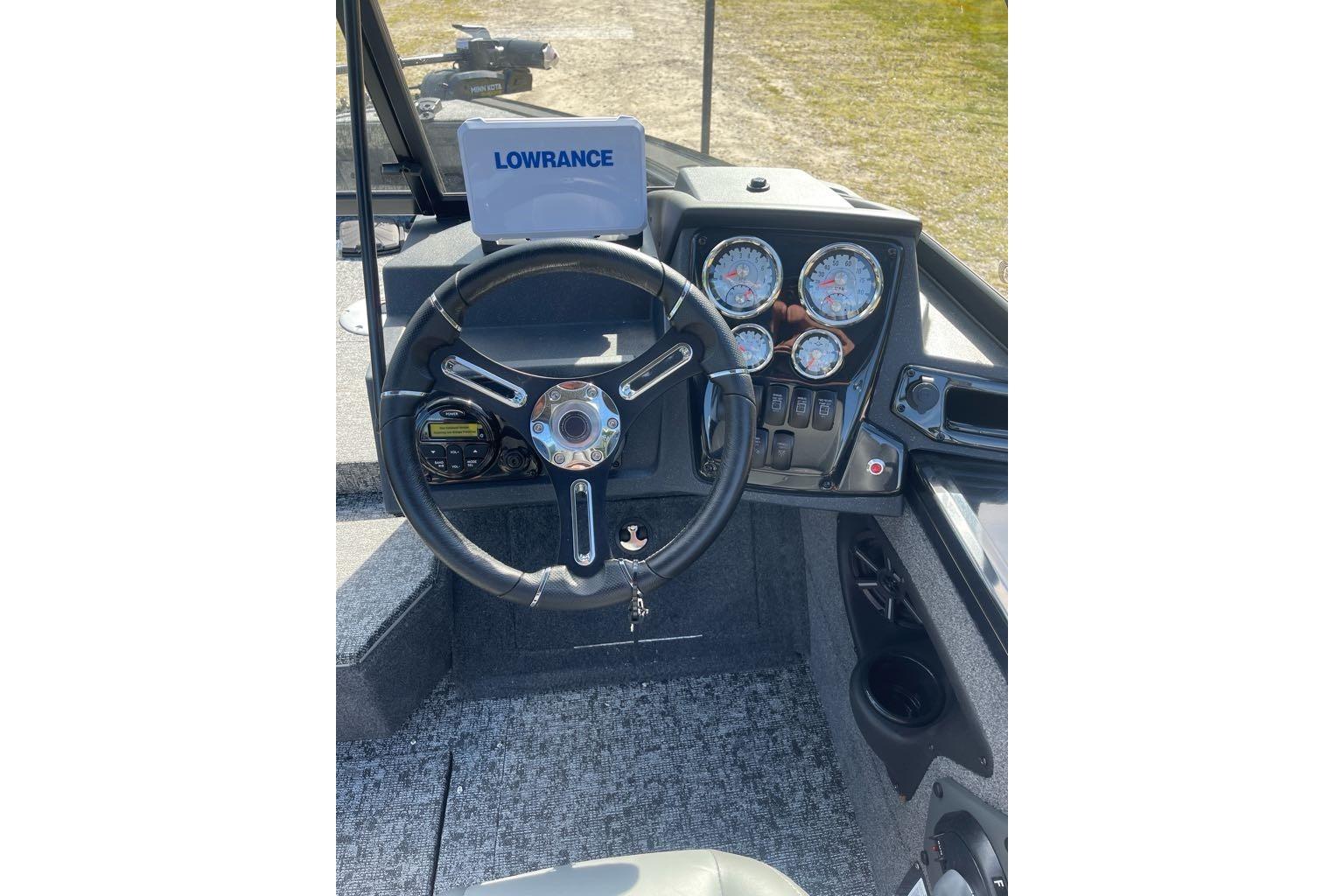 2026 Tracker Targa V-18 WT boat dashboard with steering wheel and gauges.