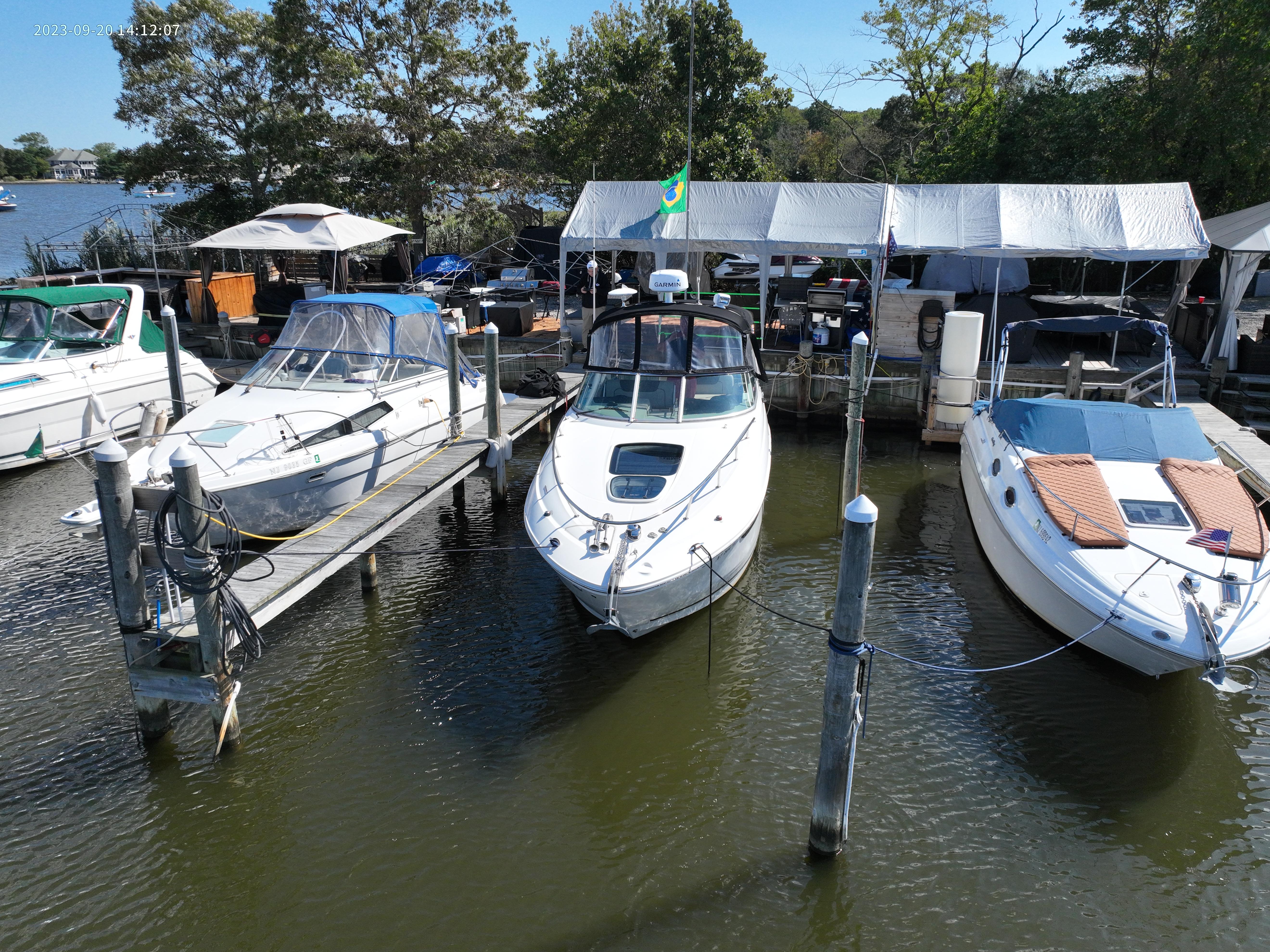 Three boats docked at a marina, including a 2014 Sea Ray Sundancer 280.