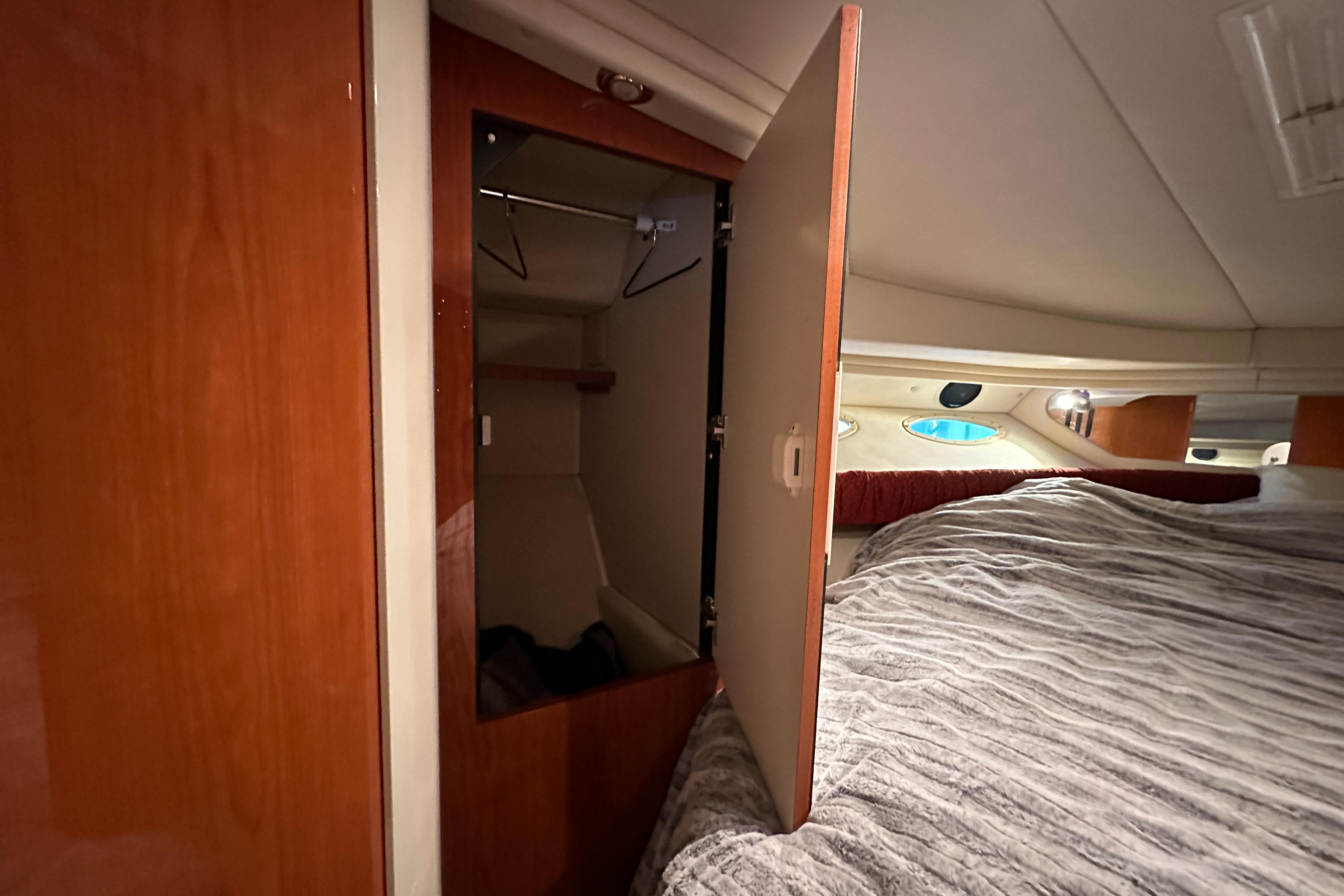 Interior cabin of 2001 Sea Ray 410 Sundancer with open closet and bed.