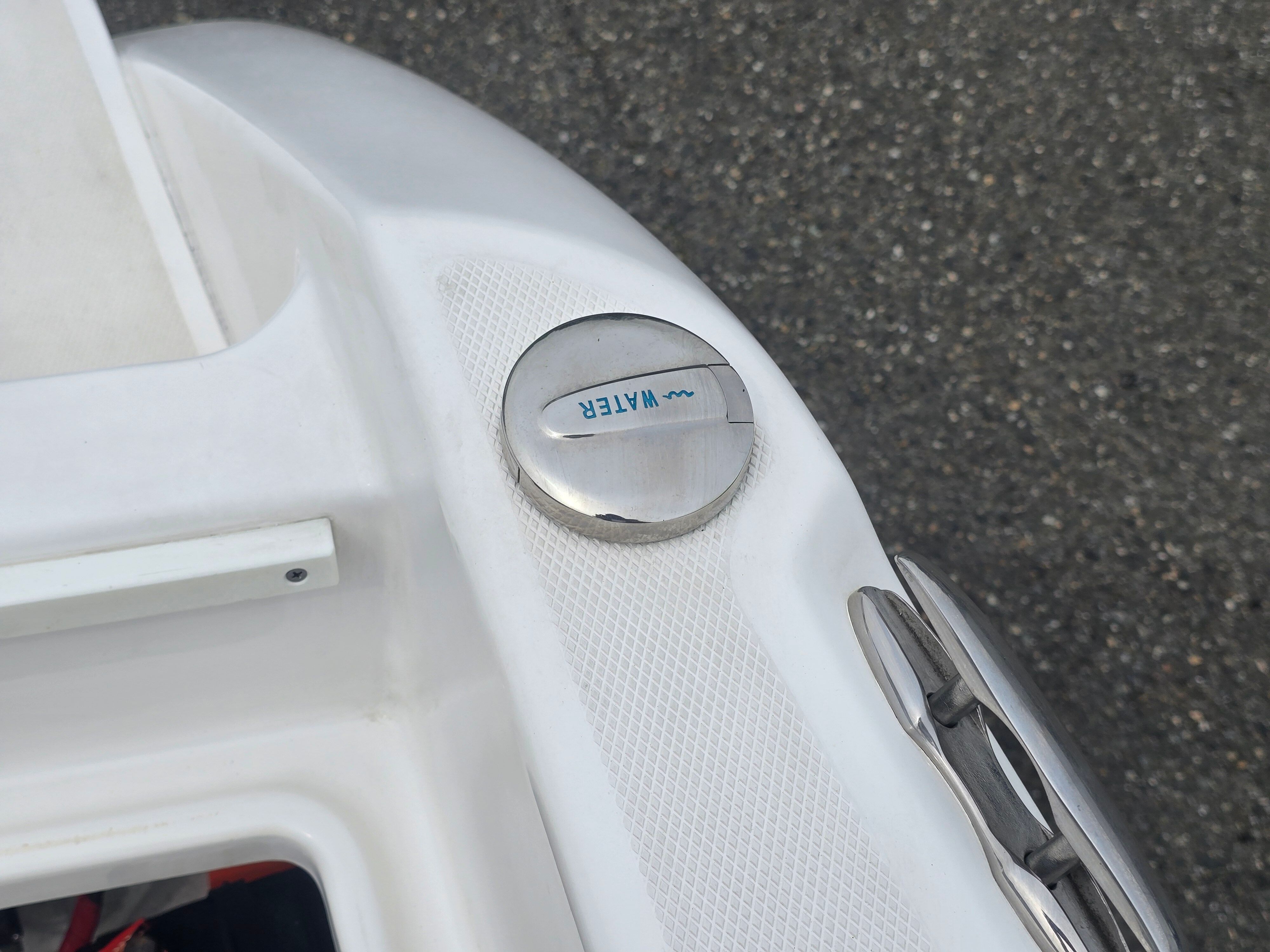 Close-up of a boat part with a water fill cap.