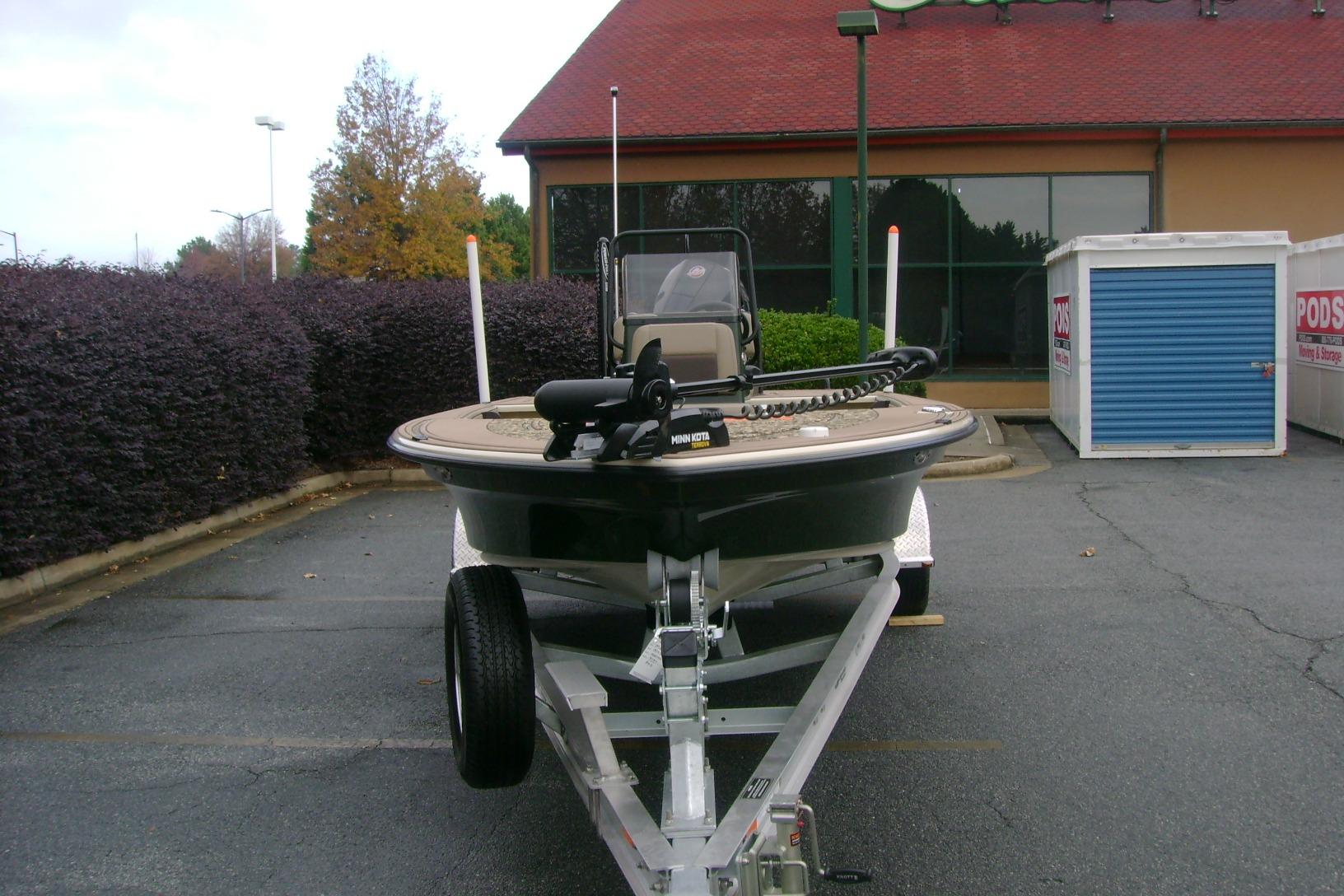 2025 Mako 18 Pro Skiff Backwater Edition on trailer in parking lot.