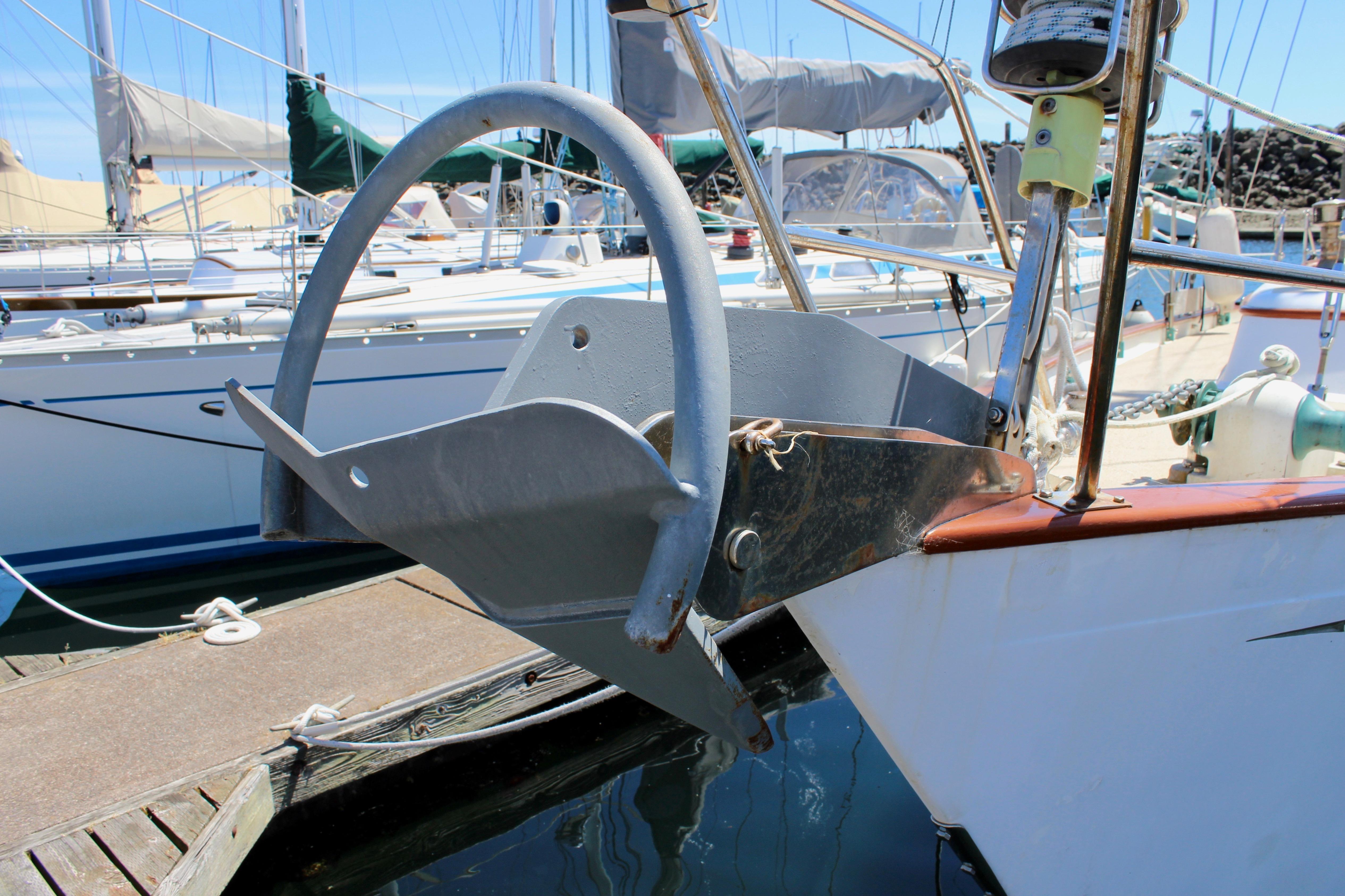 Sailboat anchor on a 1981 Kelly Peterson 46 at a marina dock.