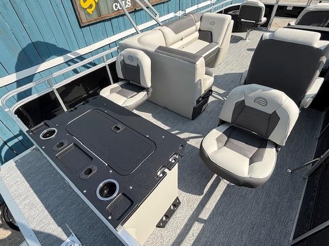 2026 Sun Tracker Fishin' Barge 20 DLX interior with seating and fishing station.