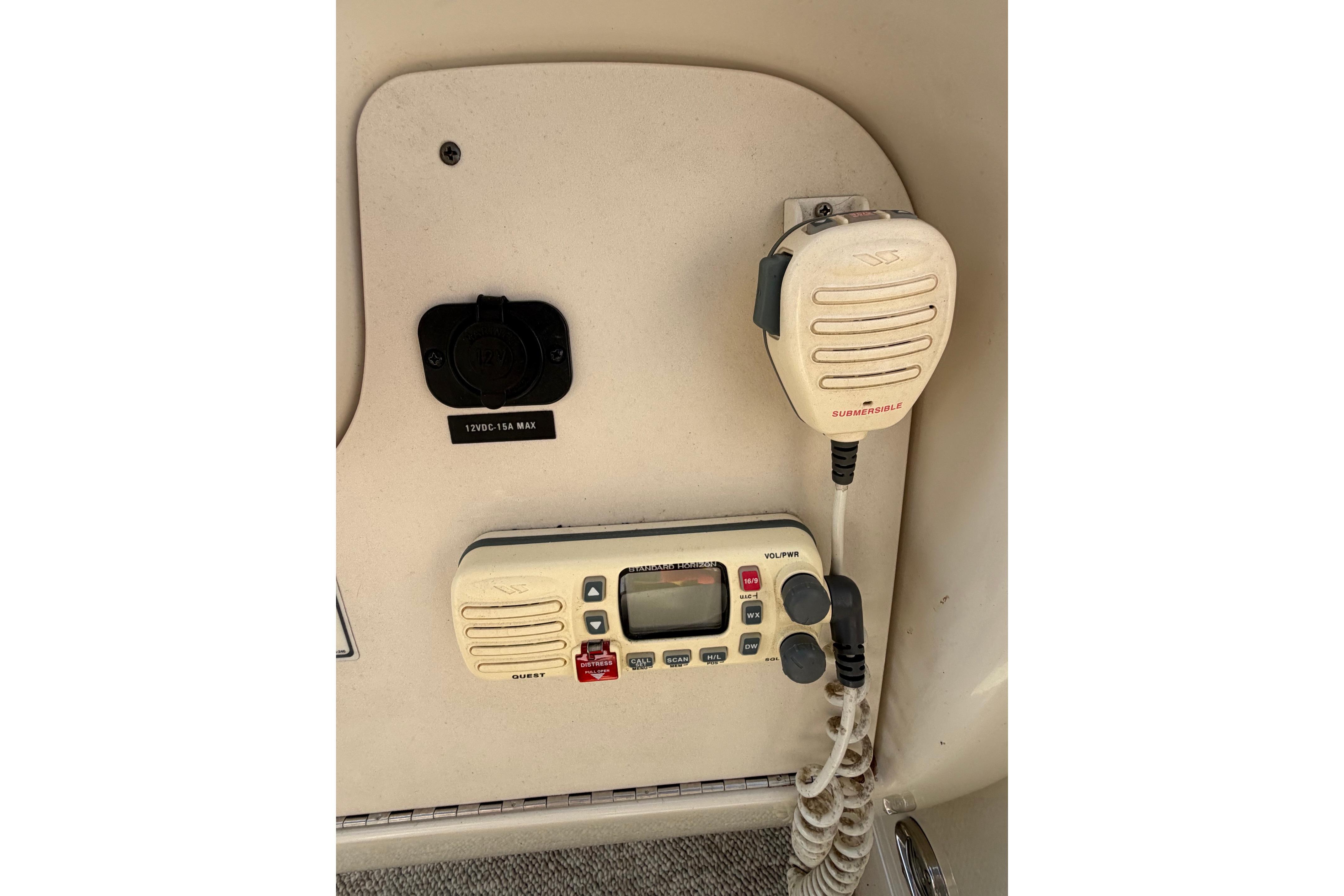 Control panel of a 2000 Sea Ray 240 Sundancer boat with radio and microphone.