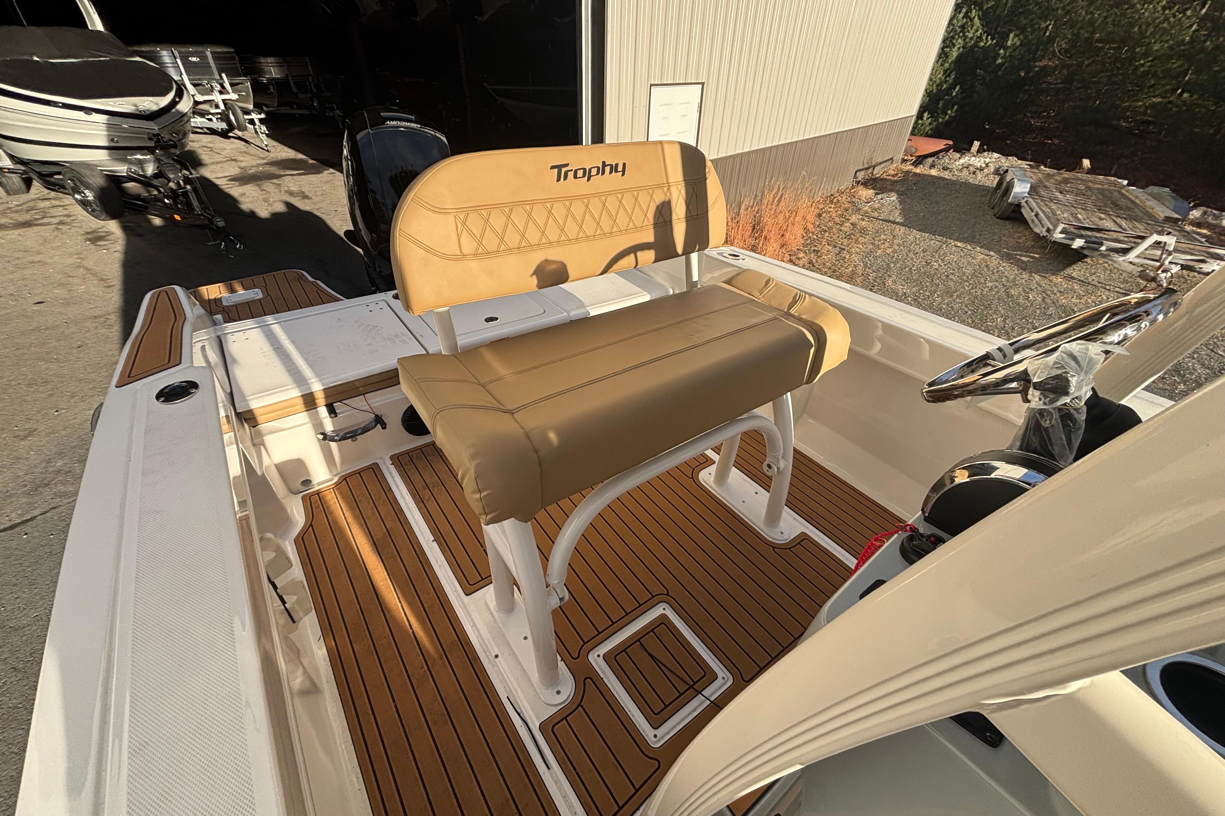 2026 Bayliner Trophy T20CC boat interior with tan seating and wood-style flooring.