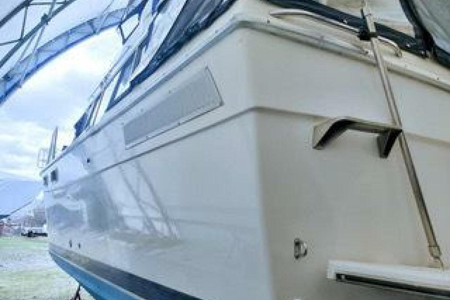 1986 Bayliner 3270 Motoryacht under a canopy, showcasing its sleek exterior design.
