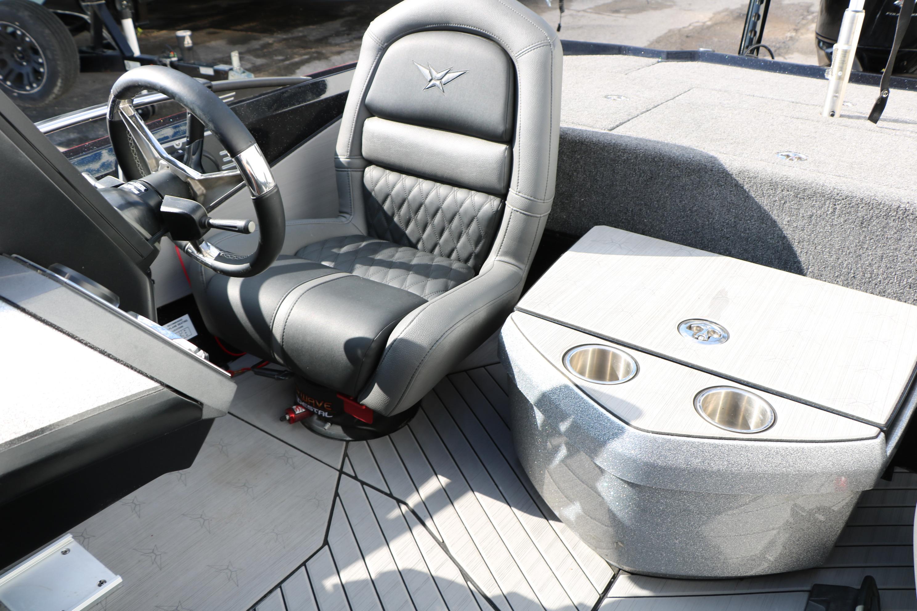 2022 Vexus VX21 boat interior with steering wheel, cushioned seat, and cup holders.