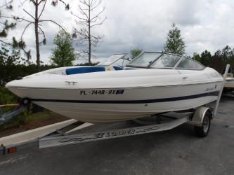 2004 Mariah SK-10 boat on trailer, parked outdoors, with trees in the background.